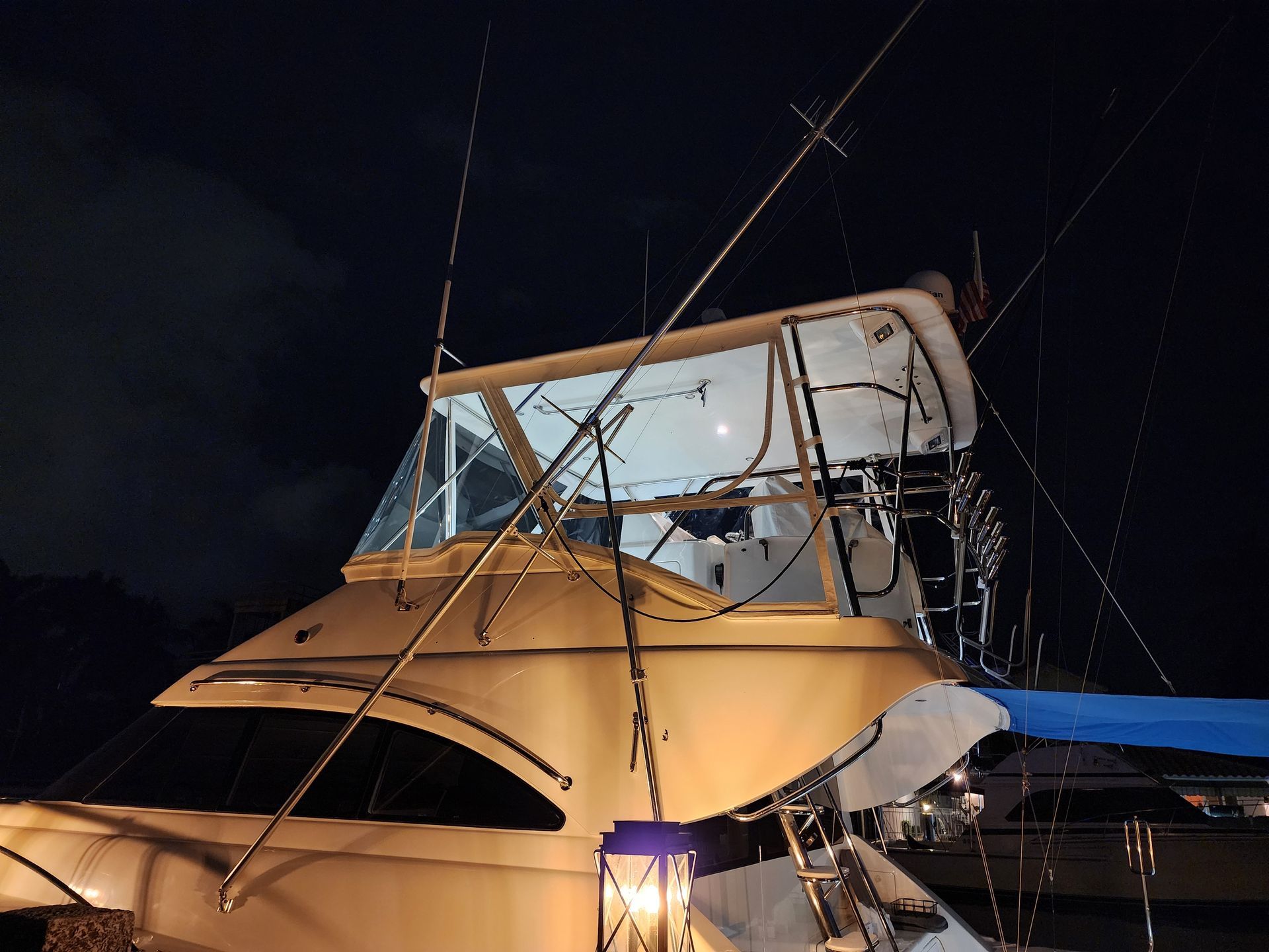 A boat is lit up at night with a lantern in front of it