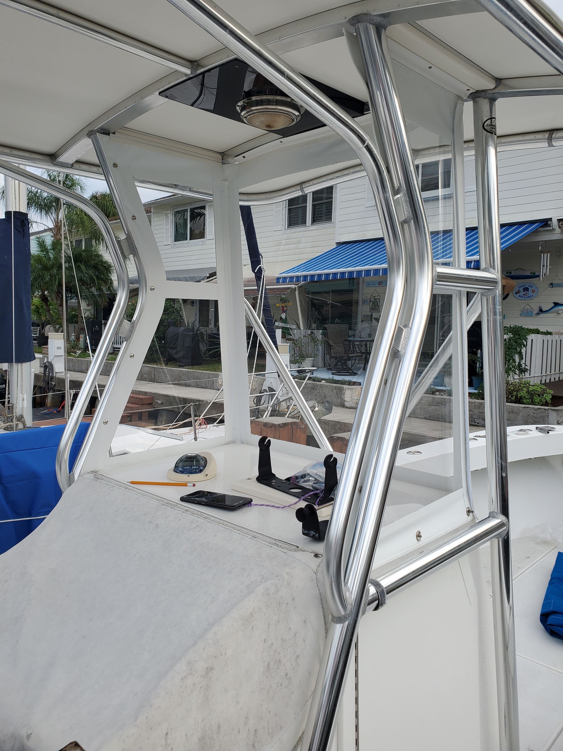A white boat with a ladder on the top of it.