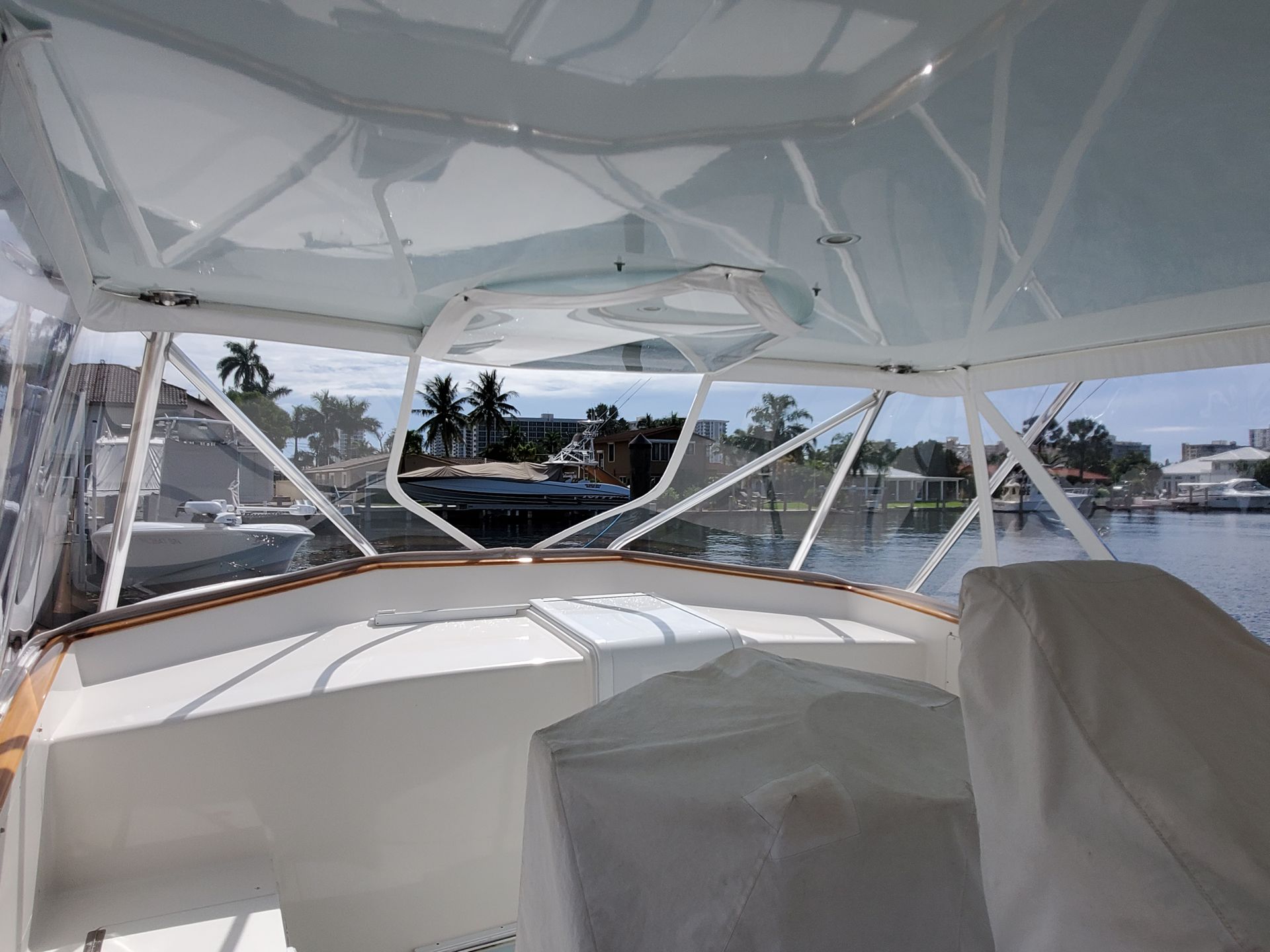 The inside of a boat with a clear roof and a view of the water.