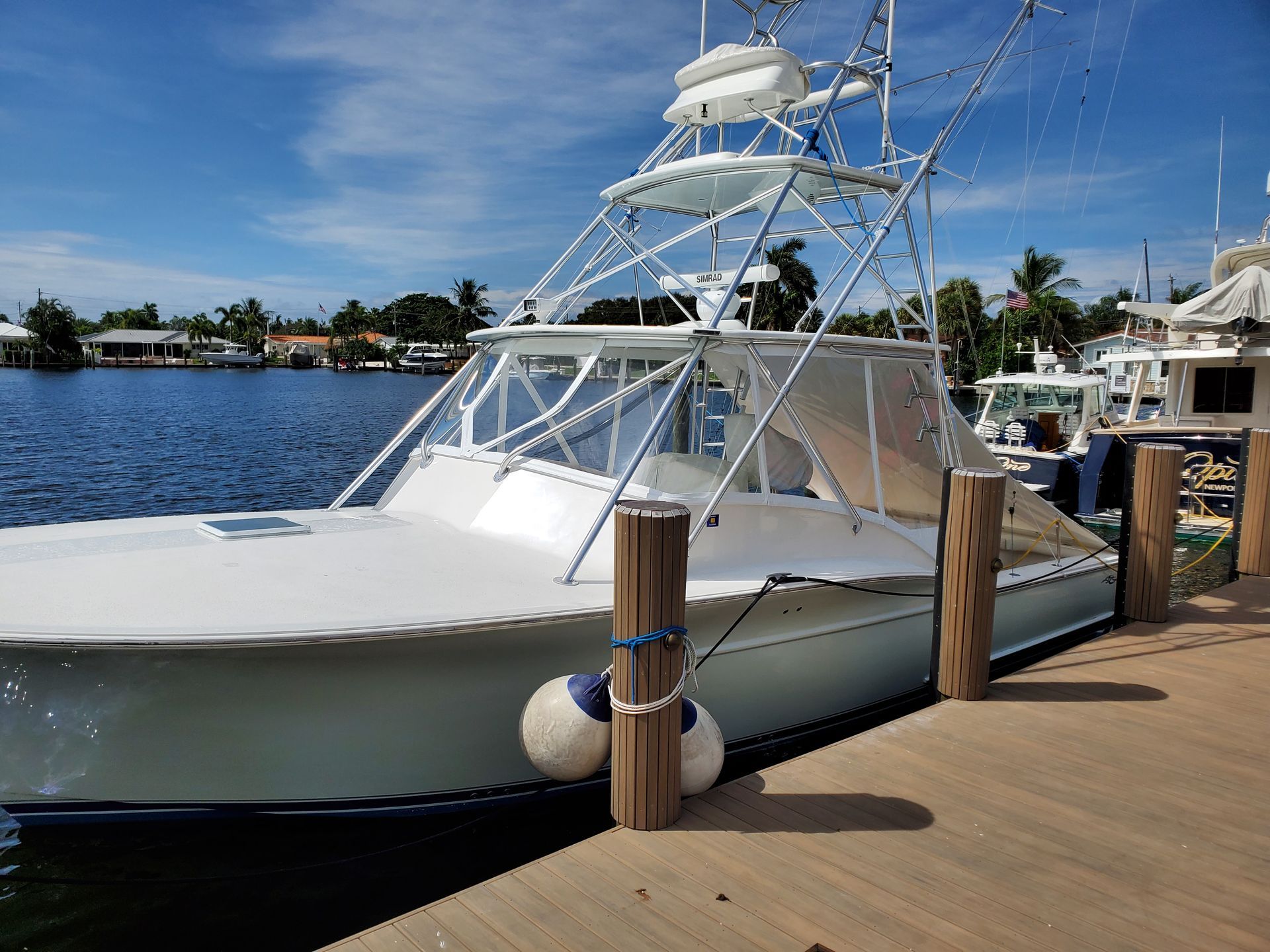 A large white boat is docked at a dock