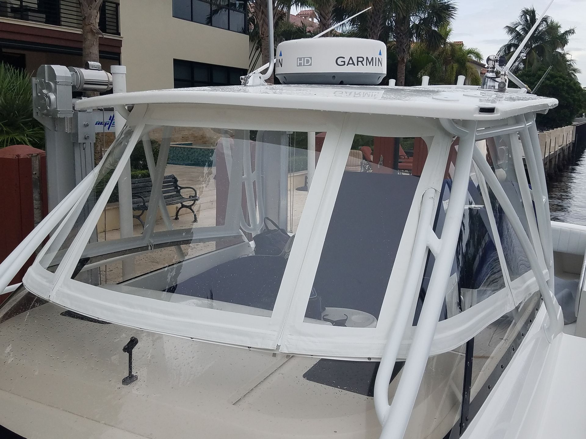 A white boat with a garmin antenna on top of it