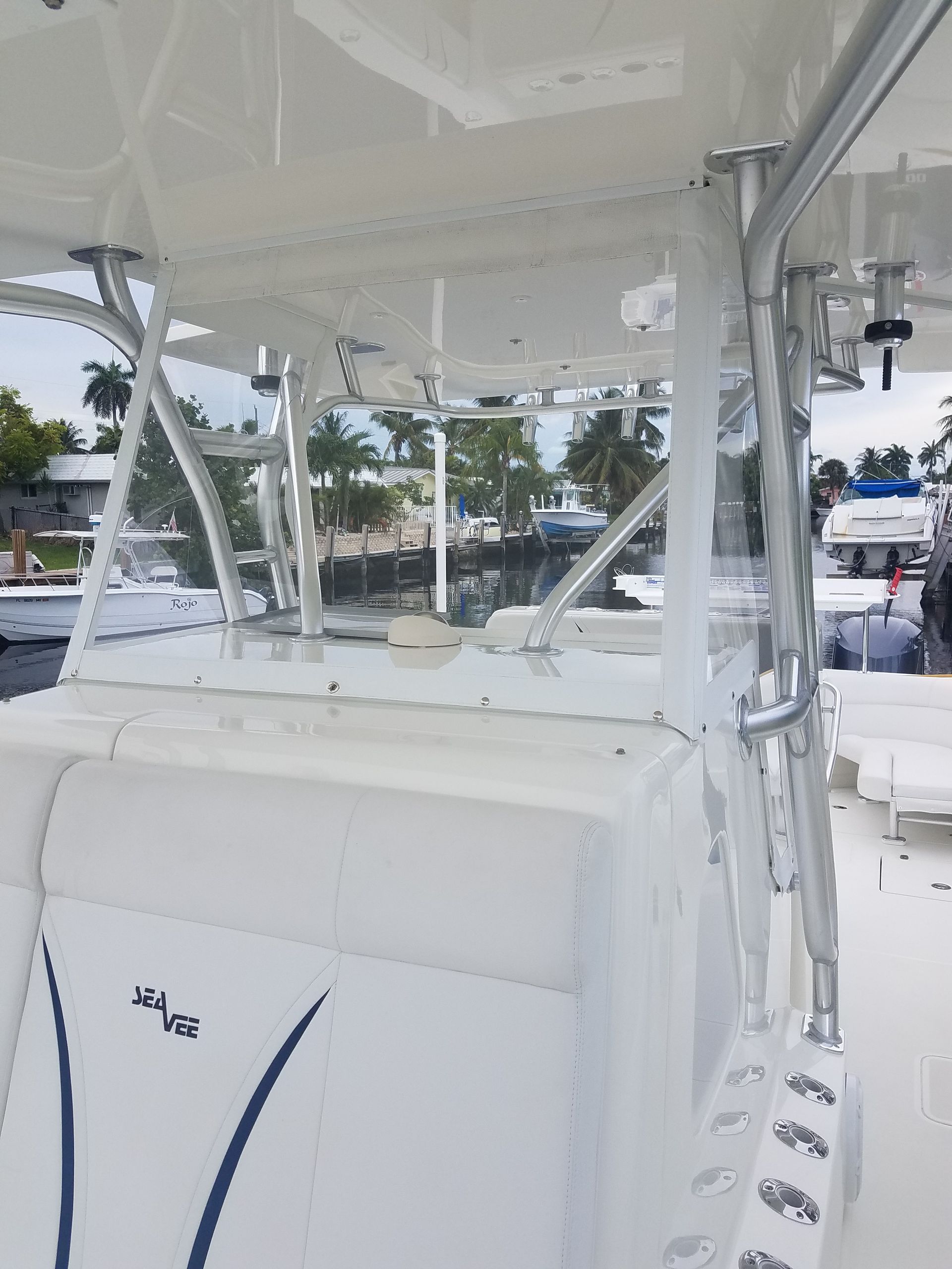 The inside of a white boat with a blue seat.