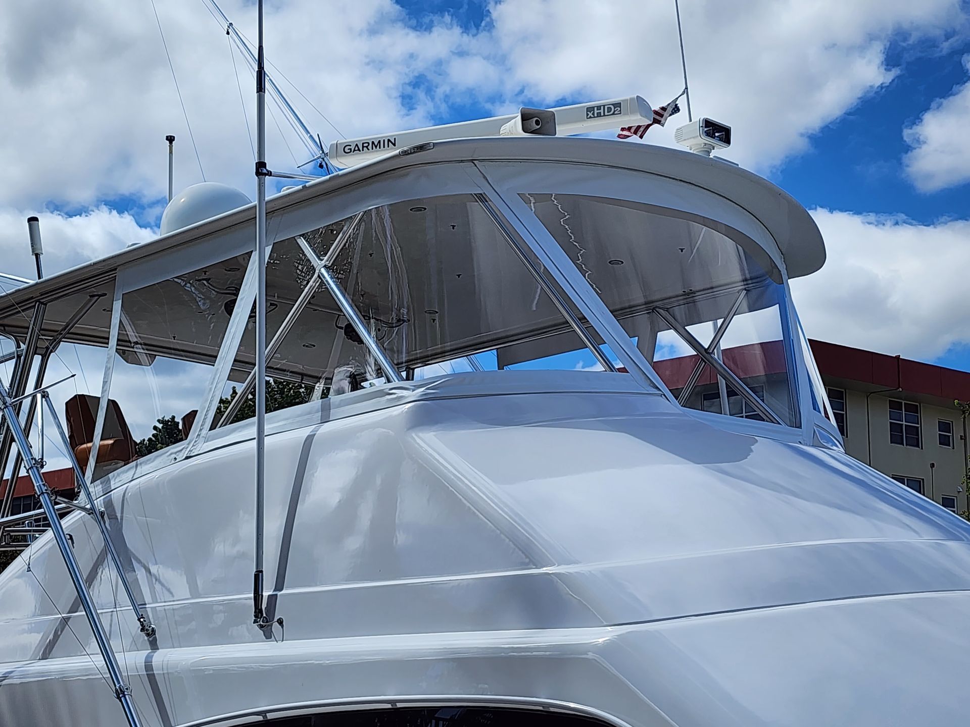 A white boat with a canopy on top of it.
