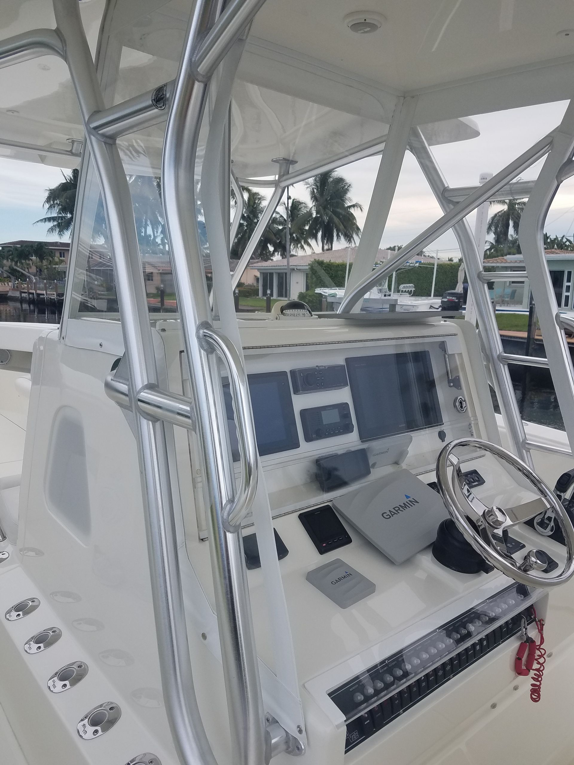A white boat with a steering wheel and a dashboard.