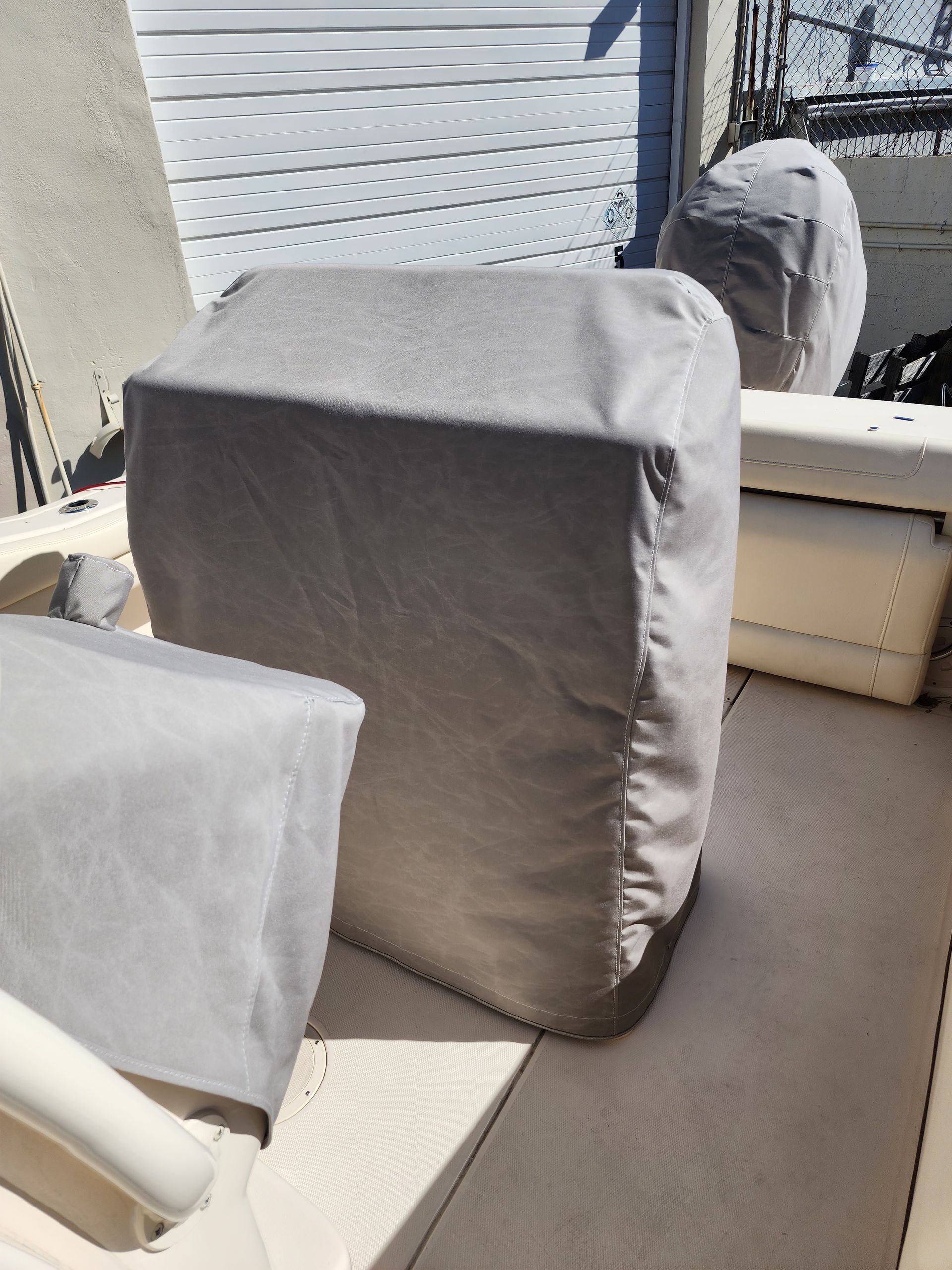 A boat with a gray cover on the seats