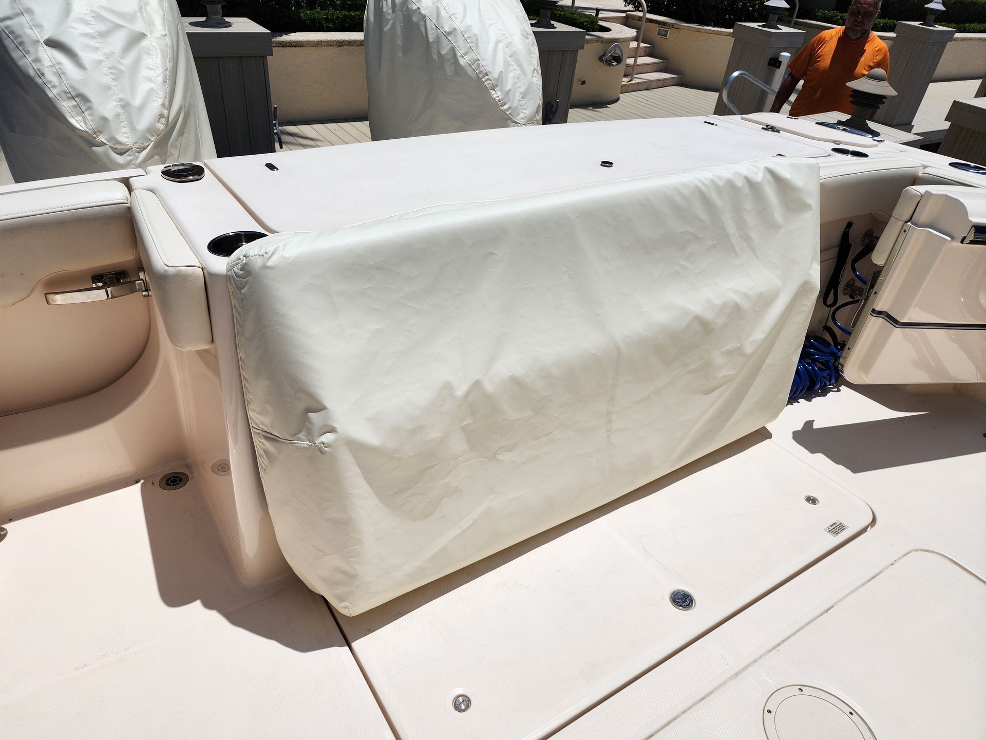 A boat with a white cover on the back of it