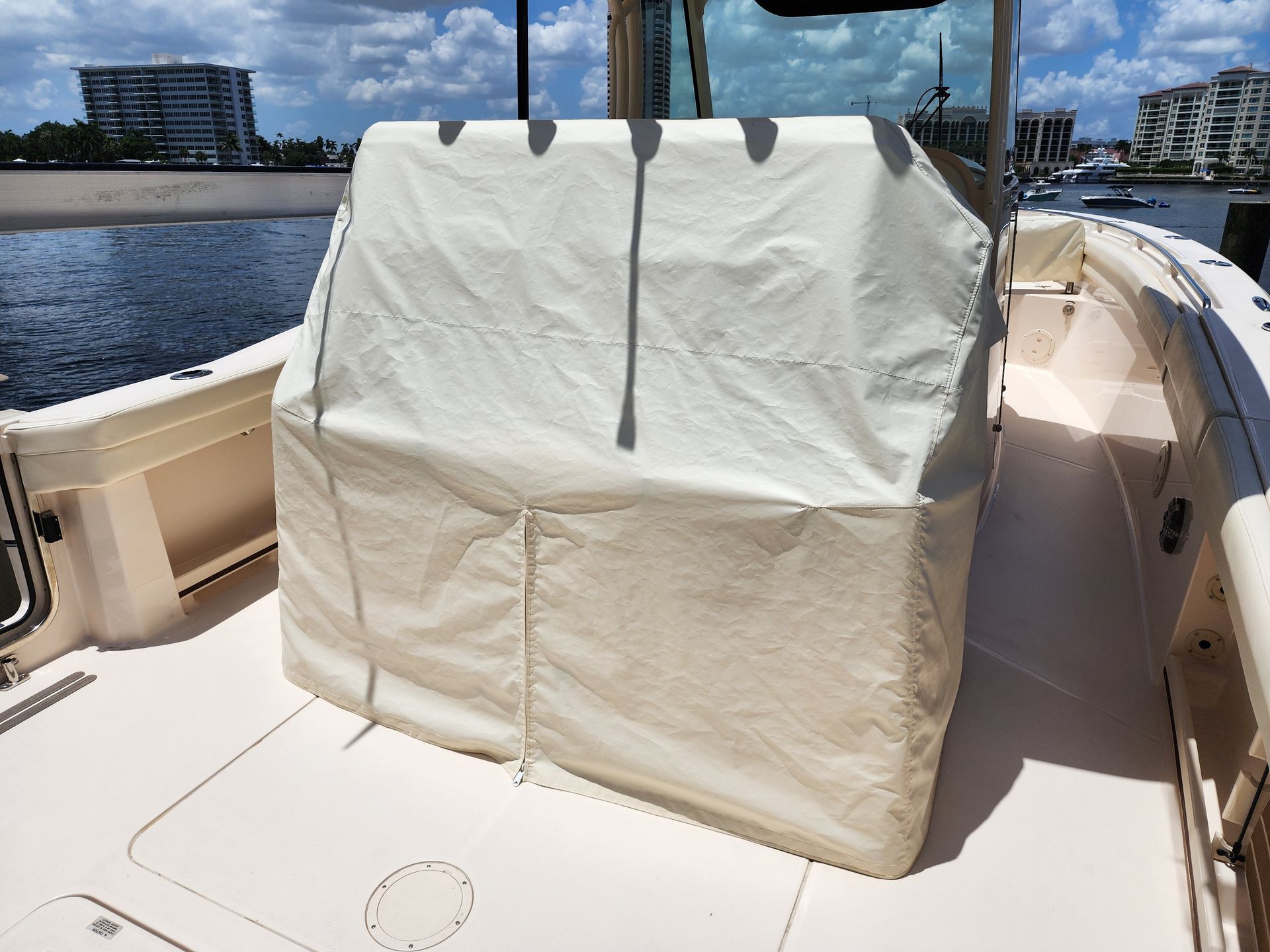 A boat with a white cover on the back of it.