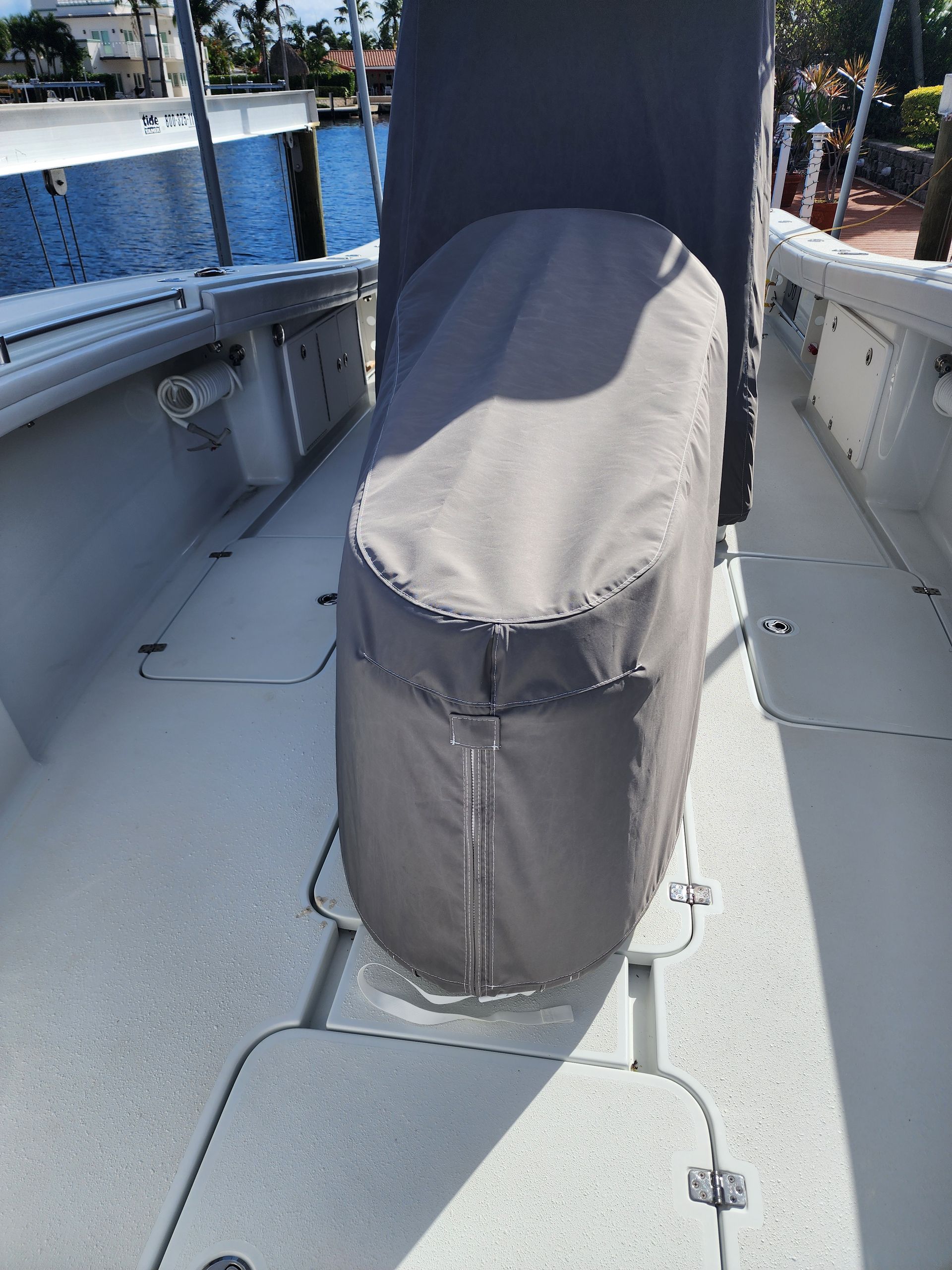 A boat with a seat cover on it is sitting in the water.