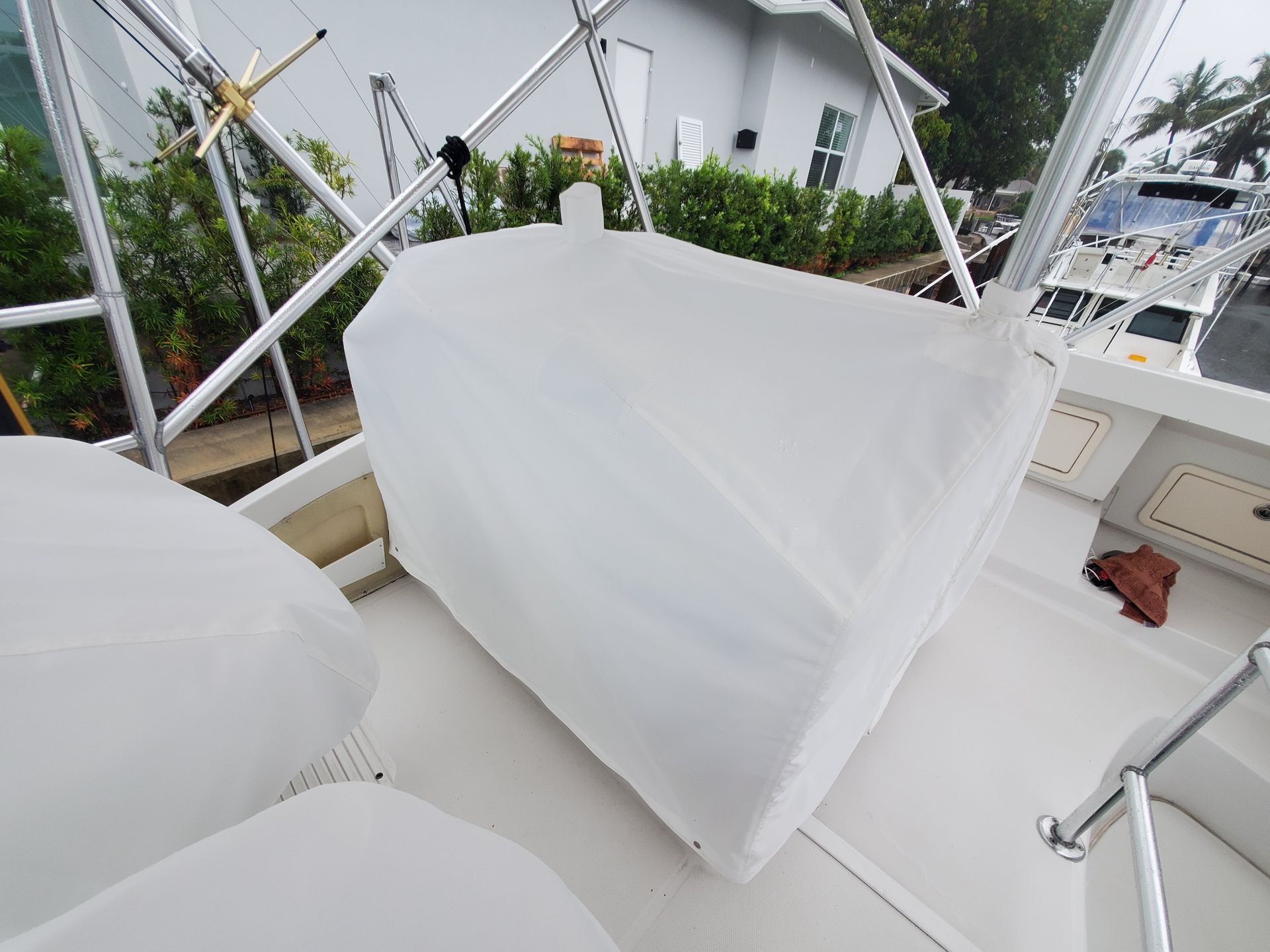 A white boat with a white cover on it