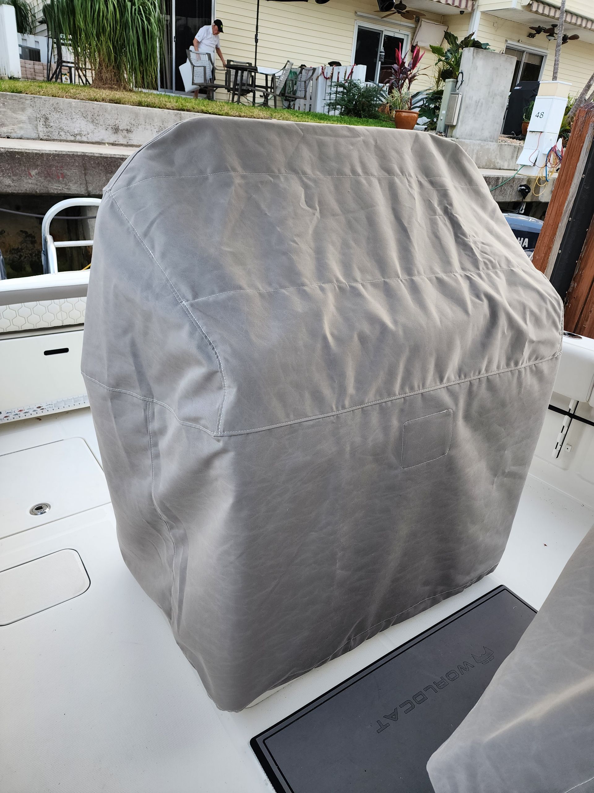A gray cover is sitting on top of a boat.
