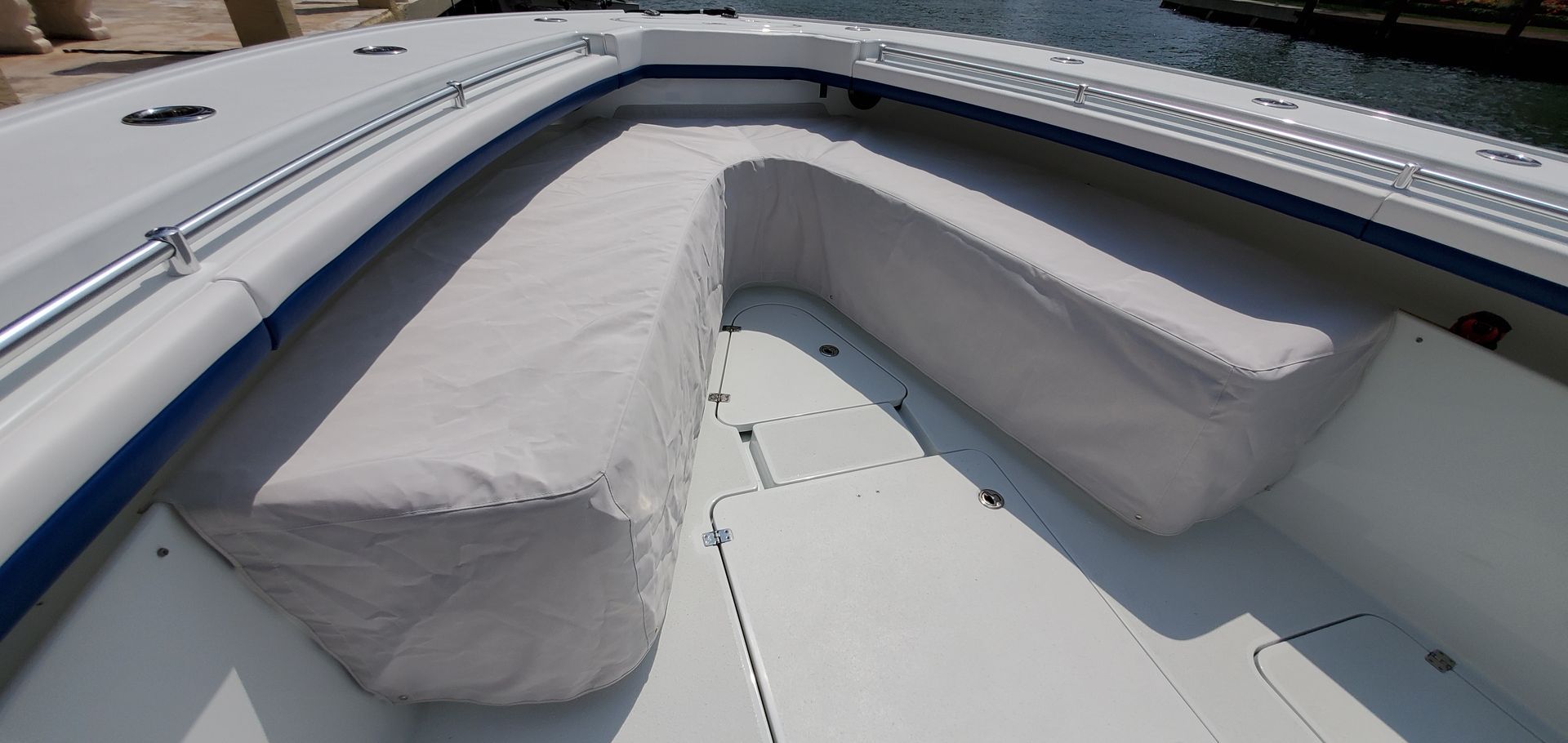 A white boat with a bench on the back of it