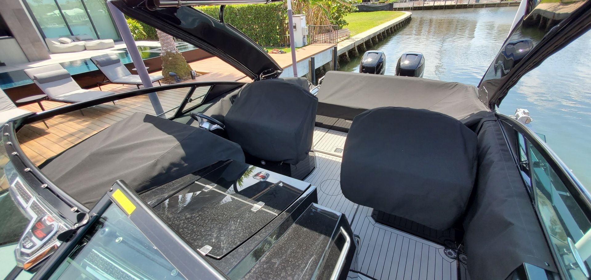 The interior of a boat is shown with a dock in the background.