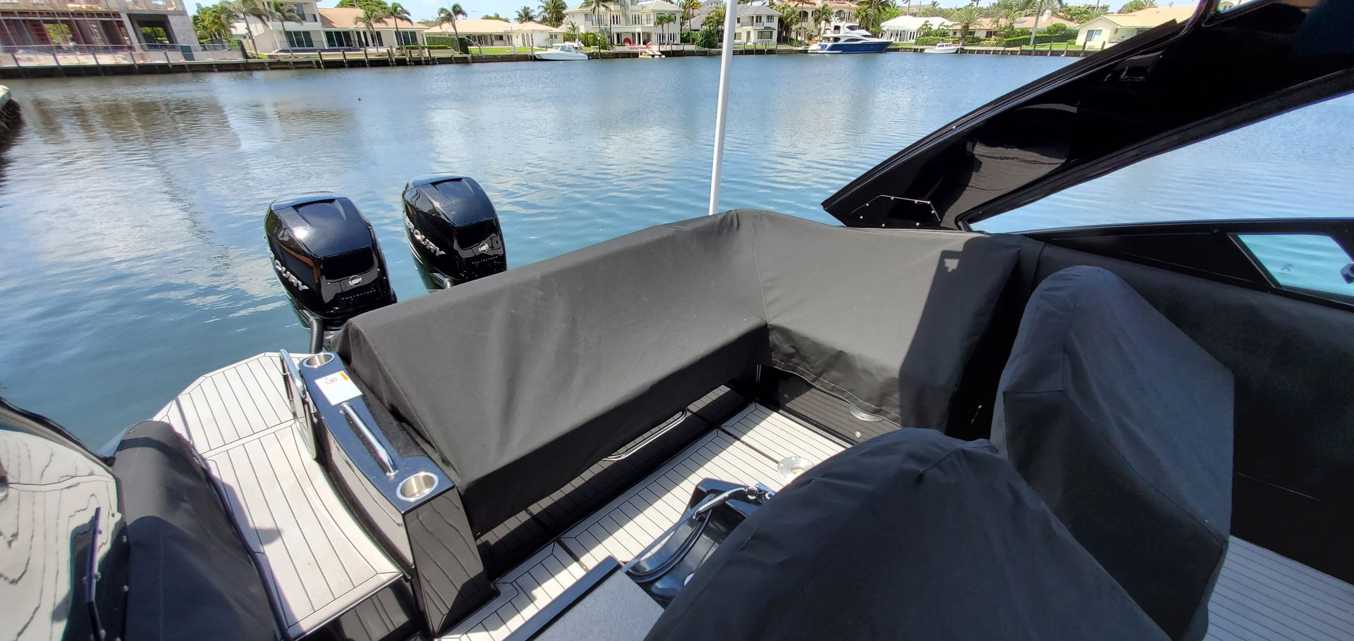 The back of a boat is sitting in the water.