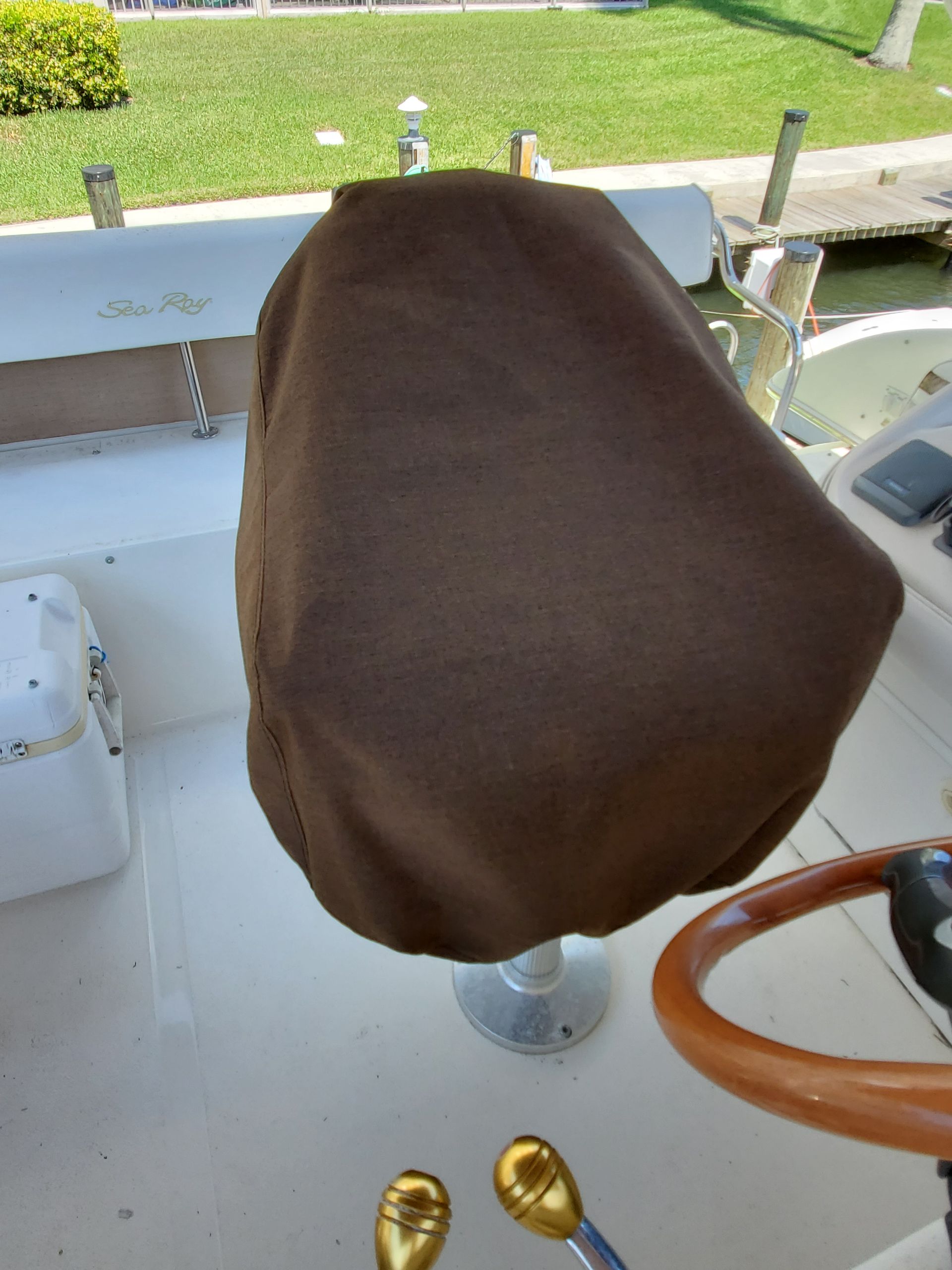 A chair on a boat with a brown cover on it
