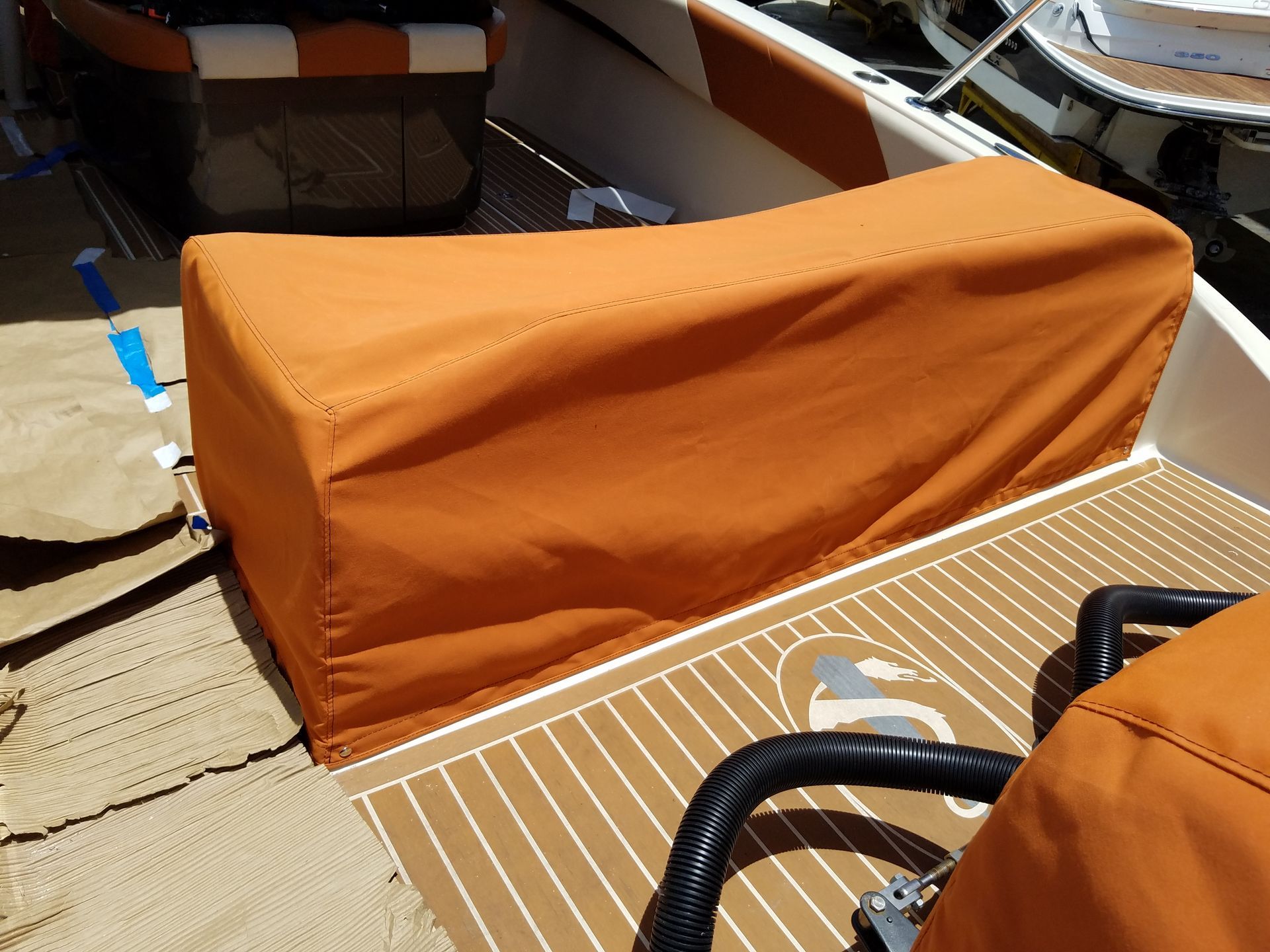 A boat with an orange seat cover on it