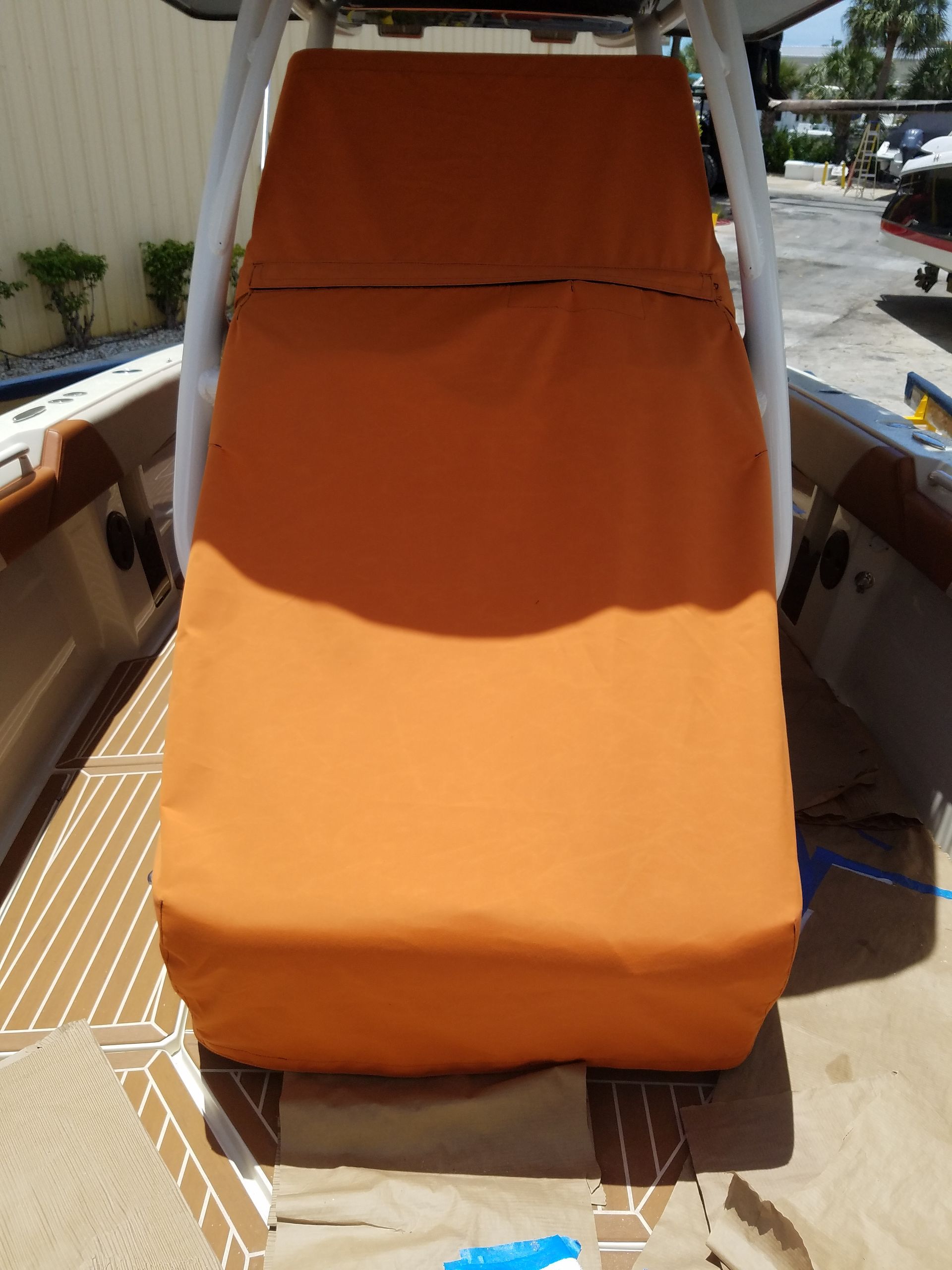 A boat with an orange seat cover on it