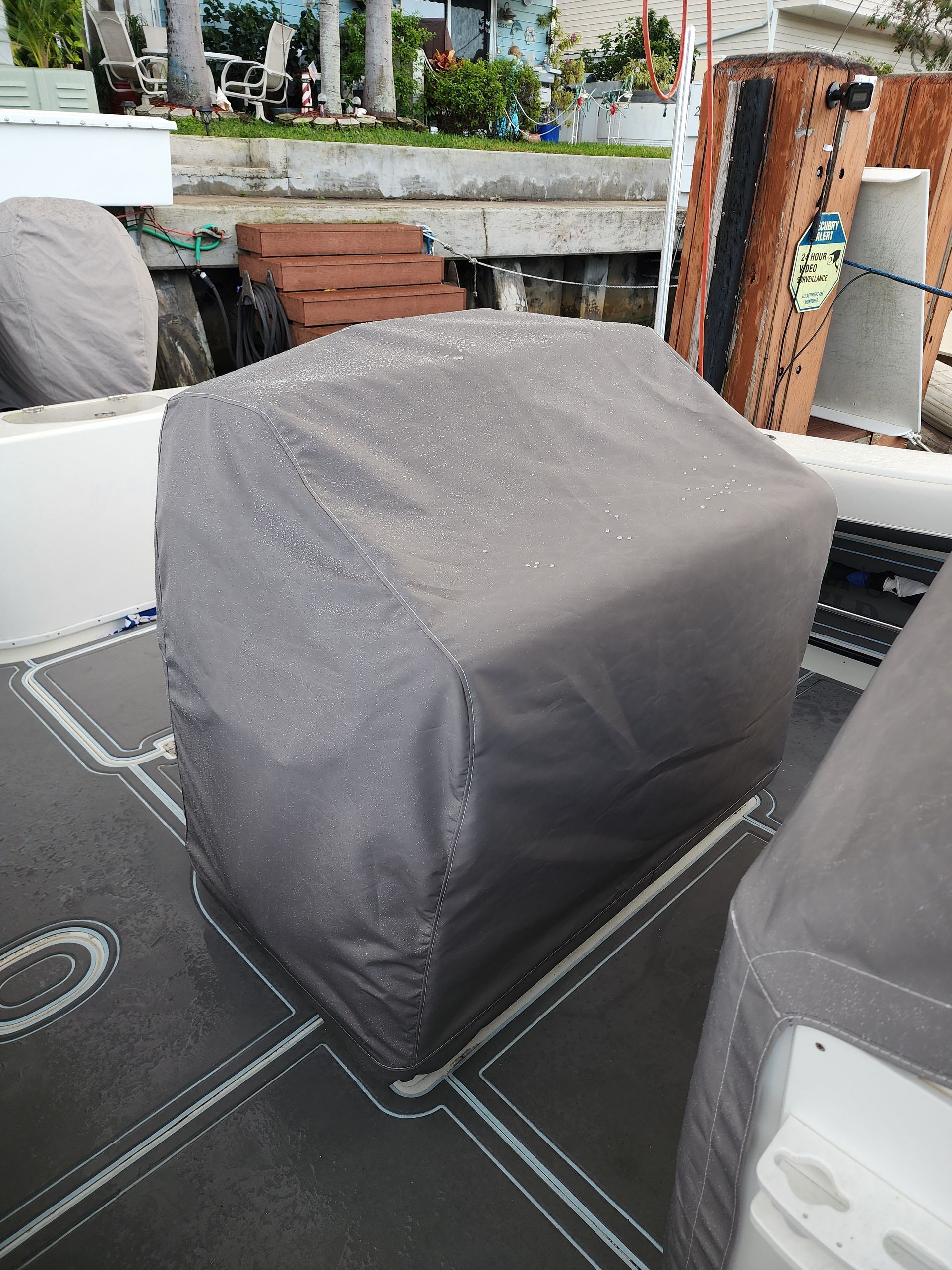 A boat with a cover on it is sitting on a dock.