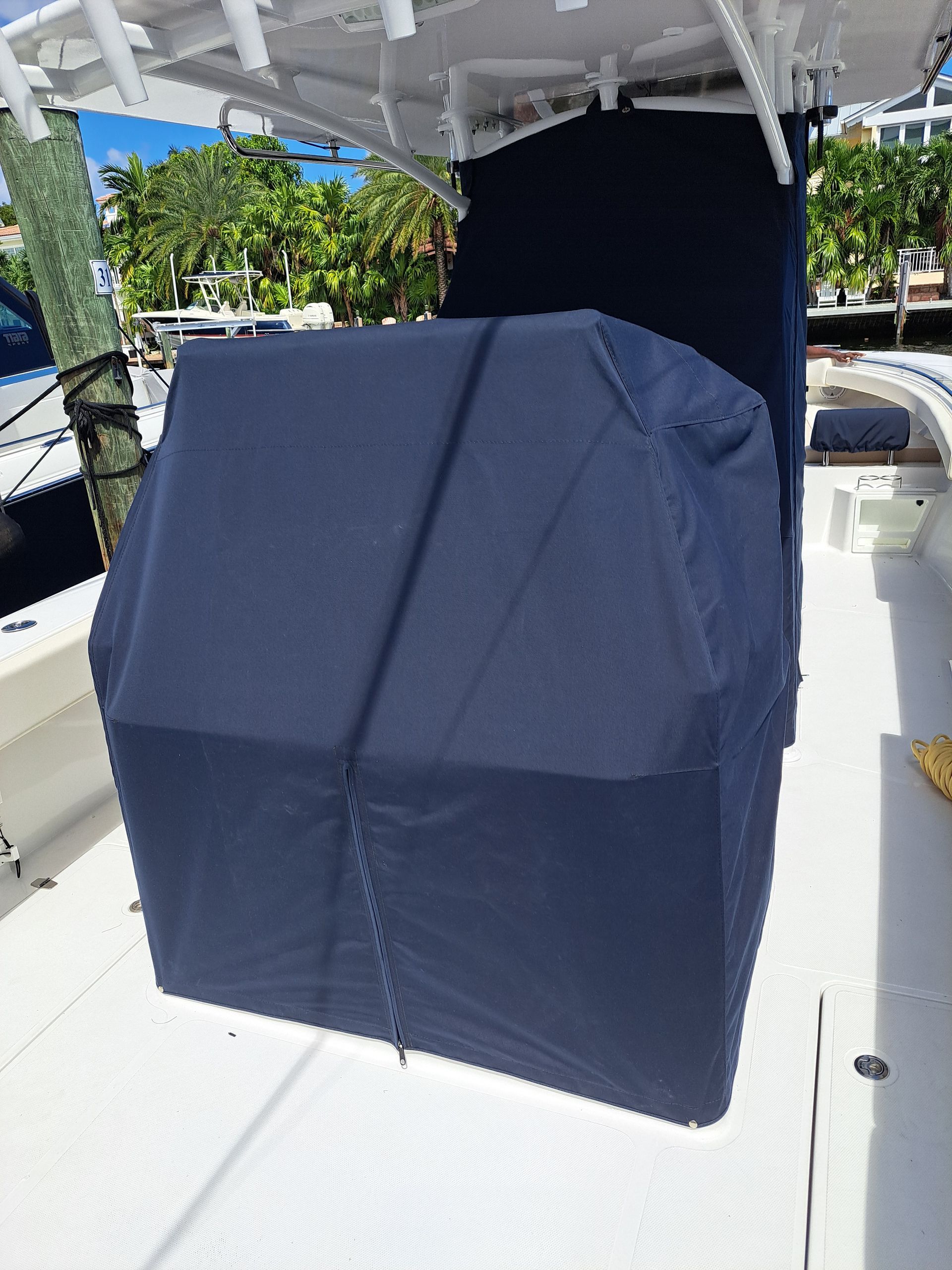 A boat with a blue cover on the top of it