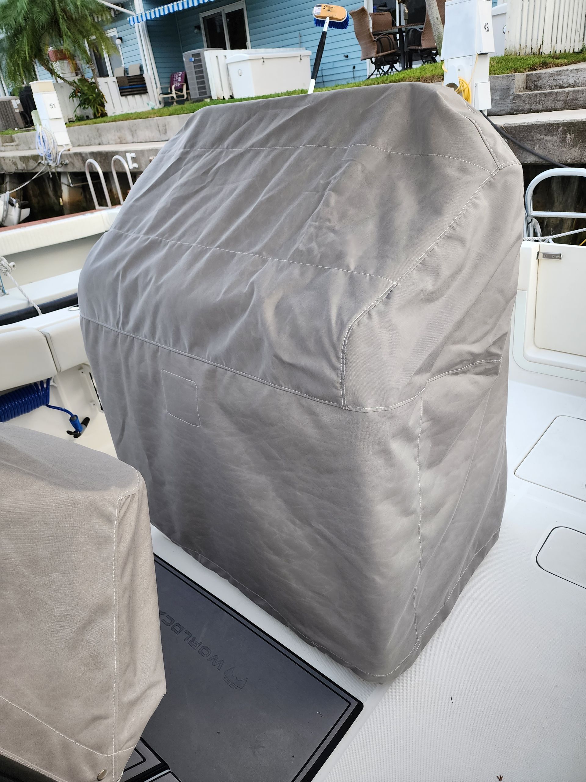 A boat with a cover on it is sitting in the water.