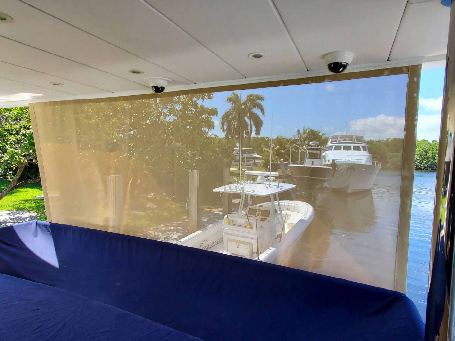A boat is docked in the water behind a screen.