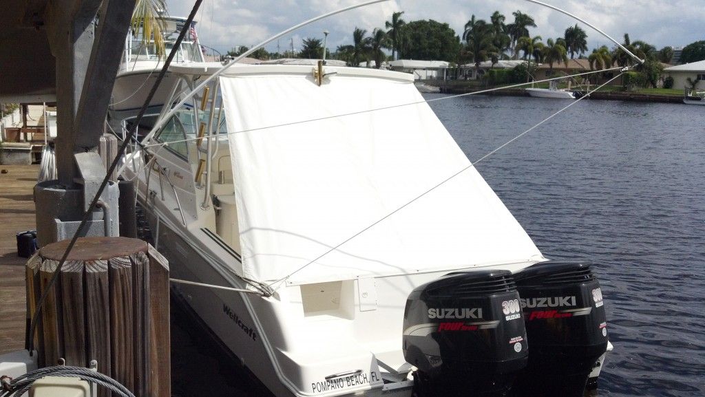 A suzuki boat is docked at a dock