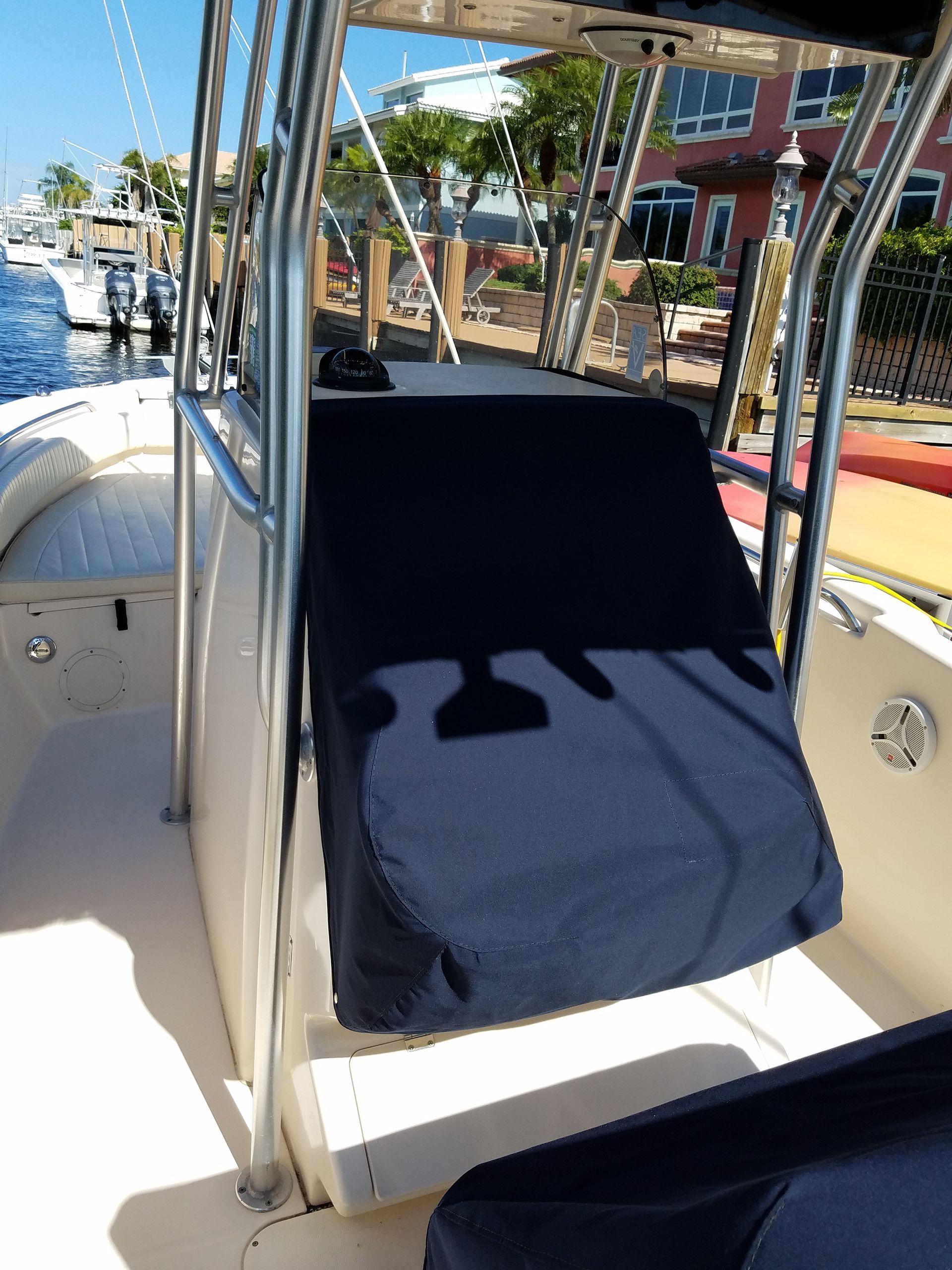 A boat with a black seat cover on it