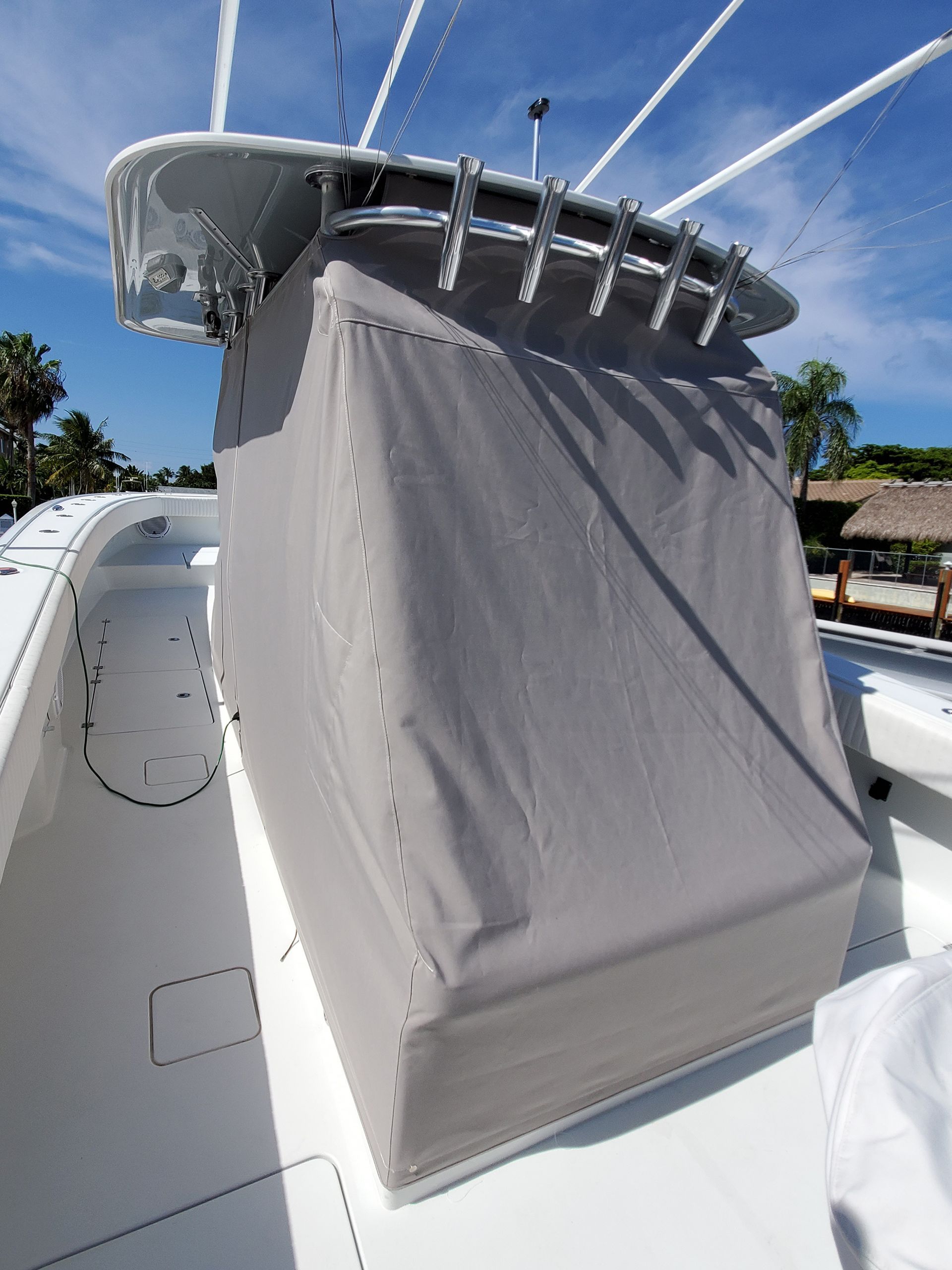 A white boat with a gray cover on top of it