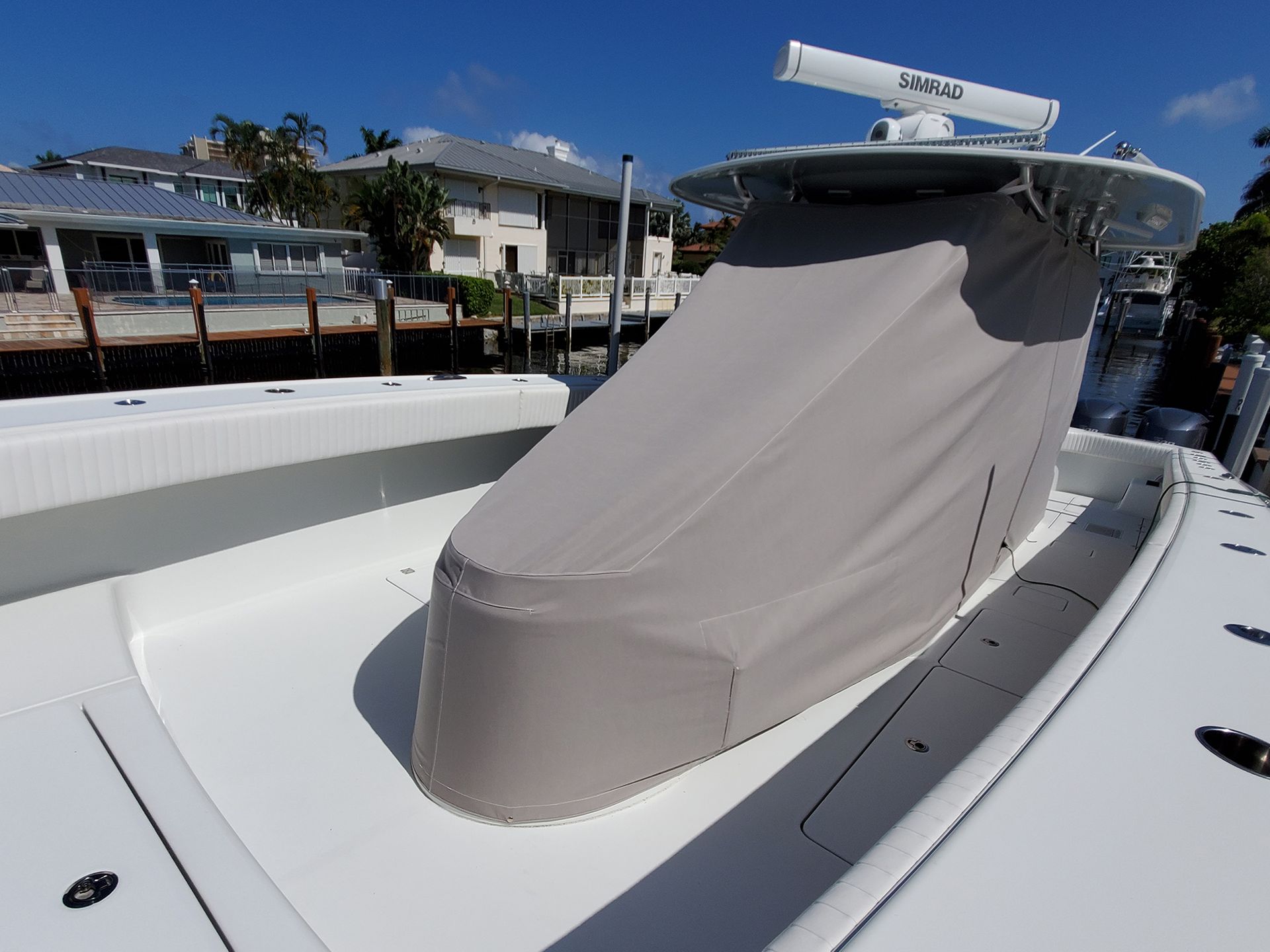 A white boat with a cover on the top of it