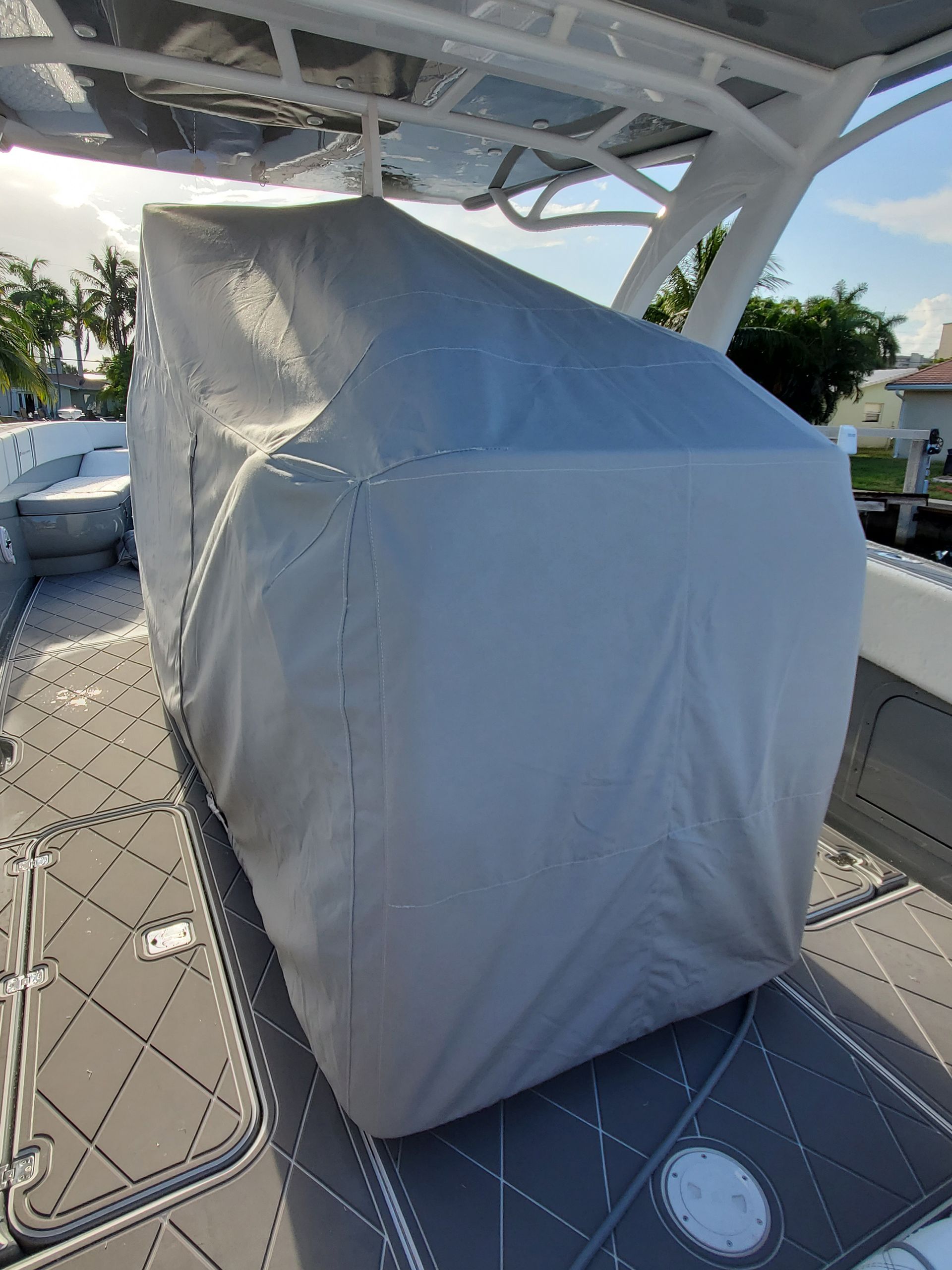 A boat with a cover on it is sitting on the deck.