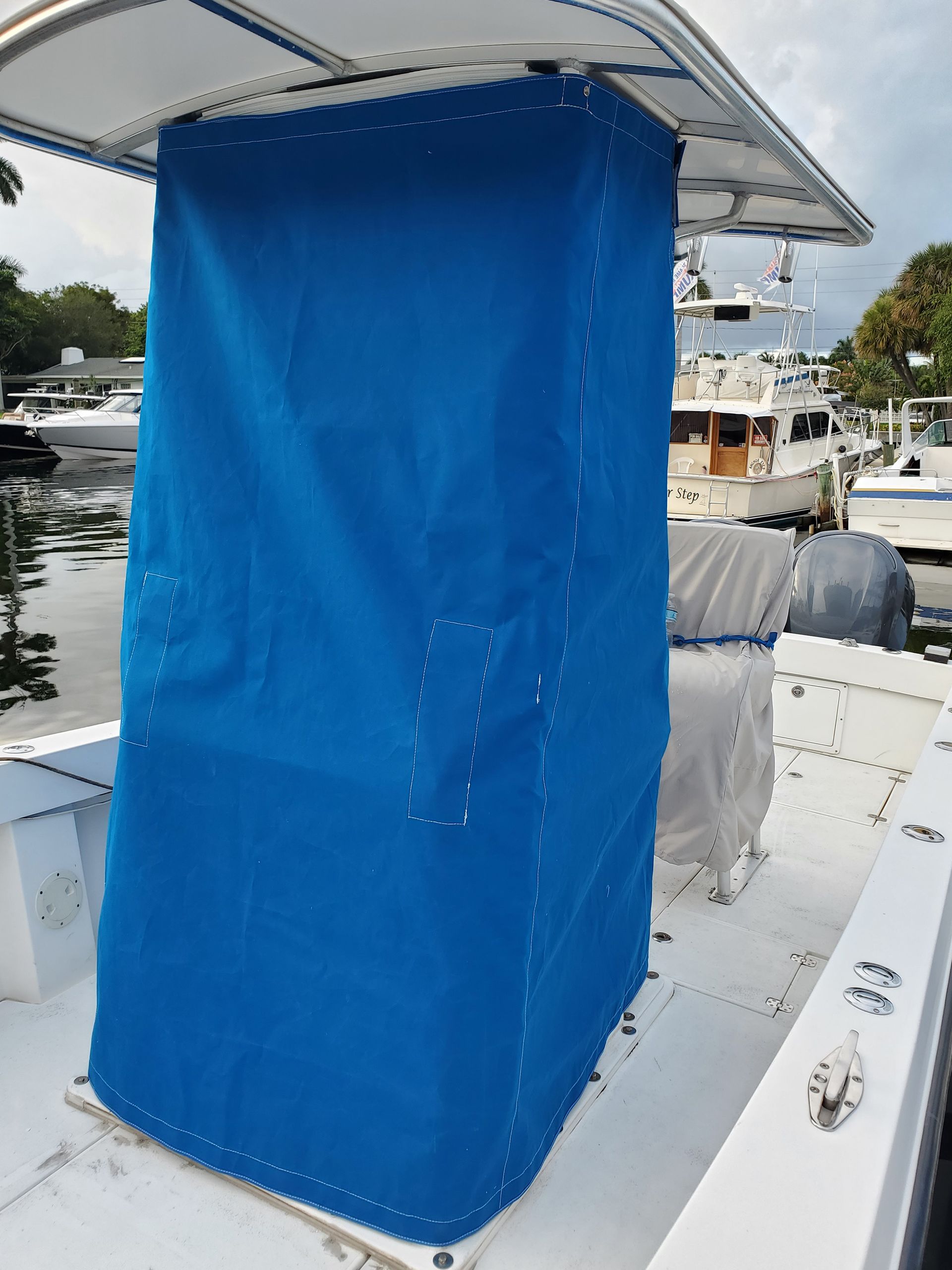 A boat with a blue cover on the top of it