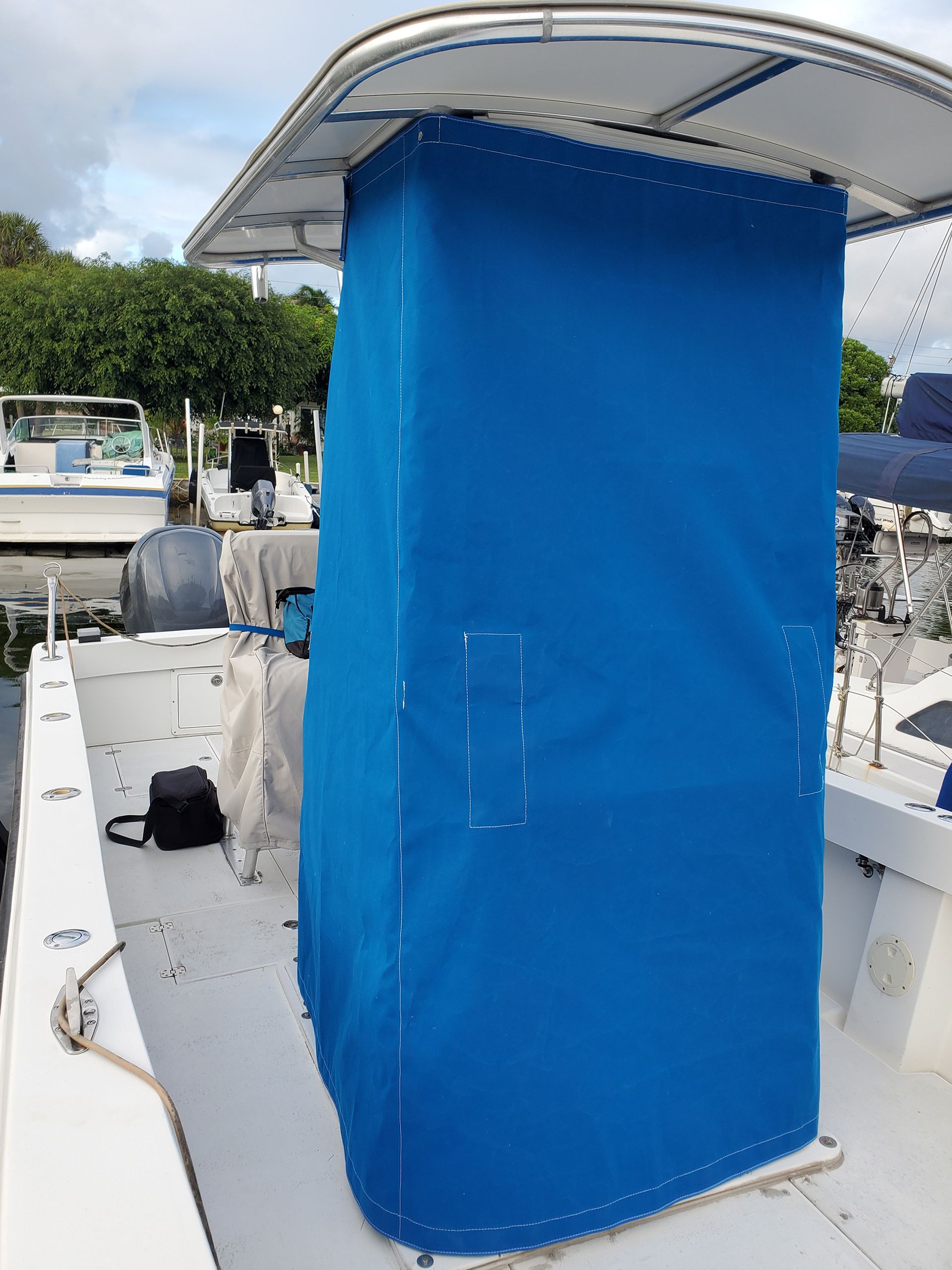 A boat with a blue cover on the top of it
