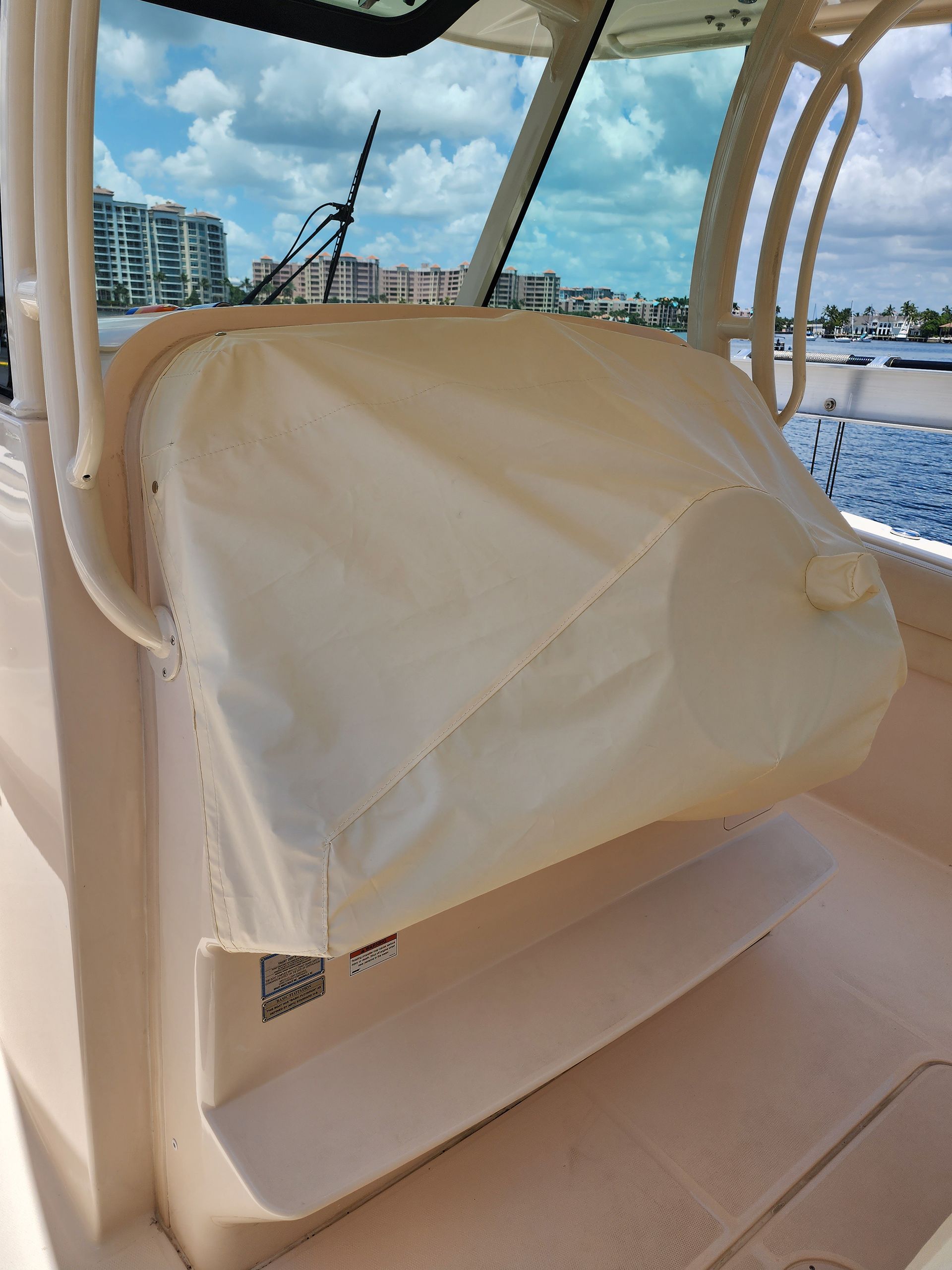 A boat with a white seat cover on it