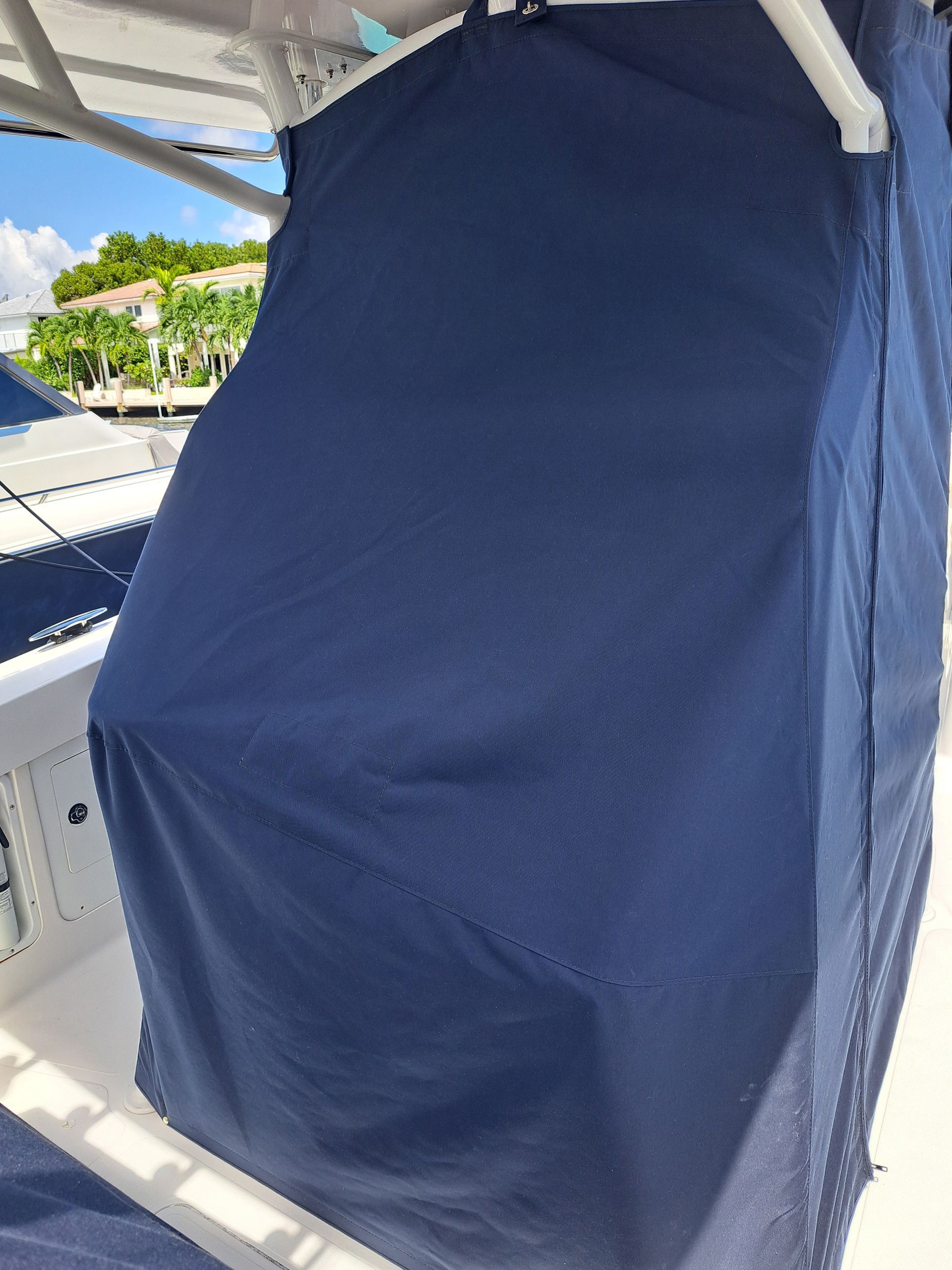 A boat with a blue cover on the side of it.