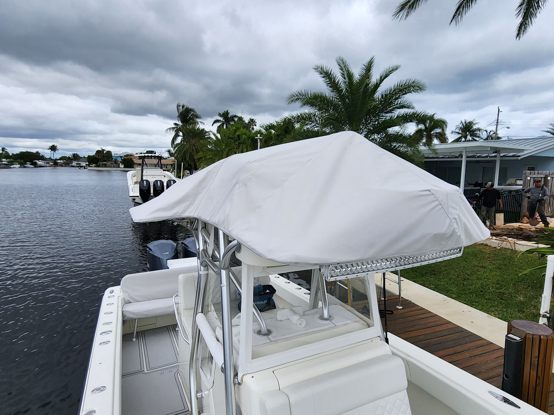 A white boat with a white cover on the top of it