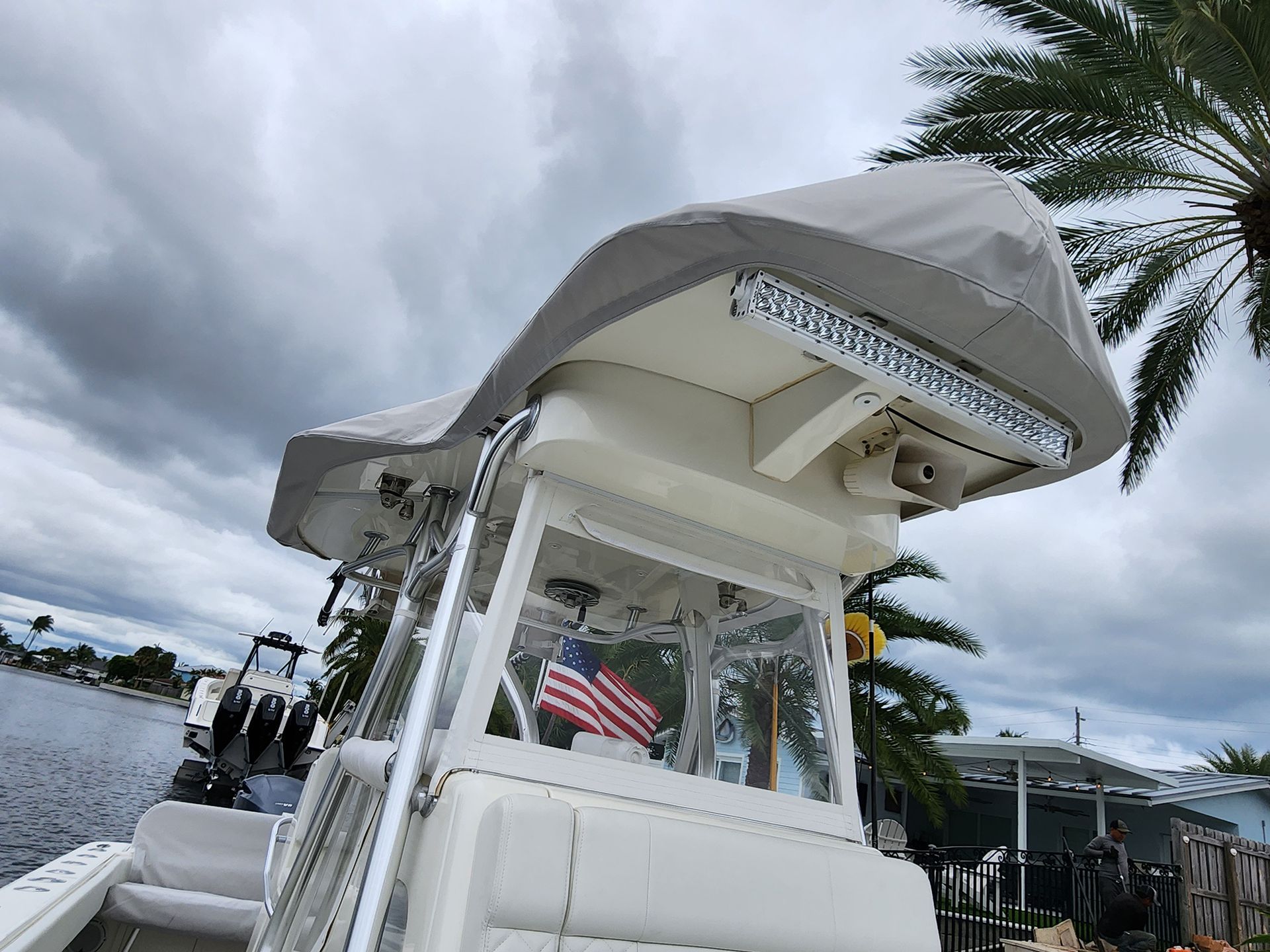 A boat with a canopy on top of it is floating on a body of water.
