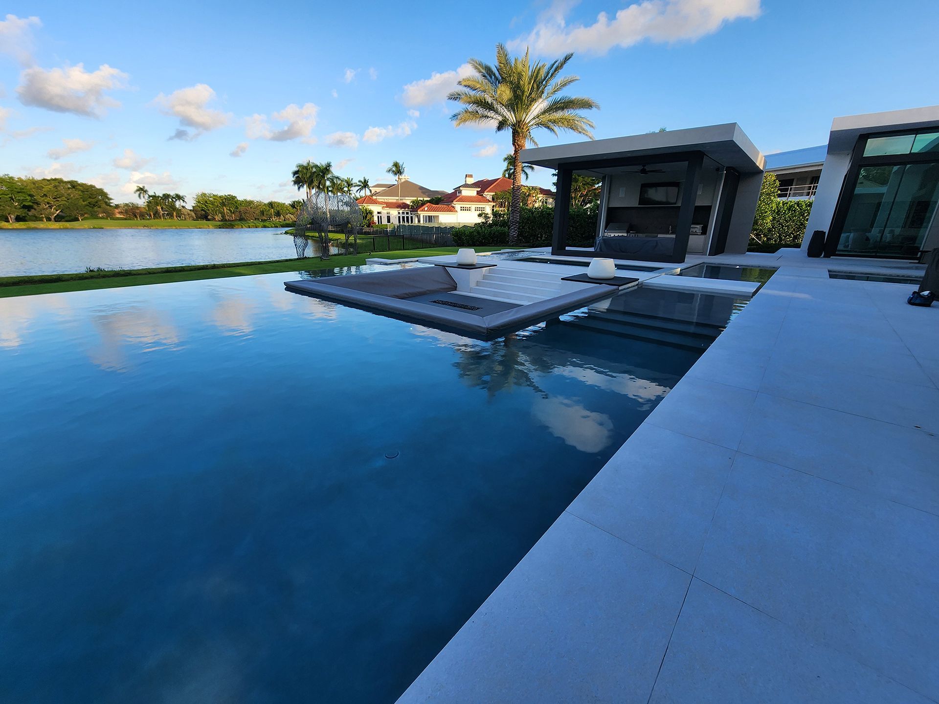 A large swimming pool with a palm tree in the background