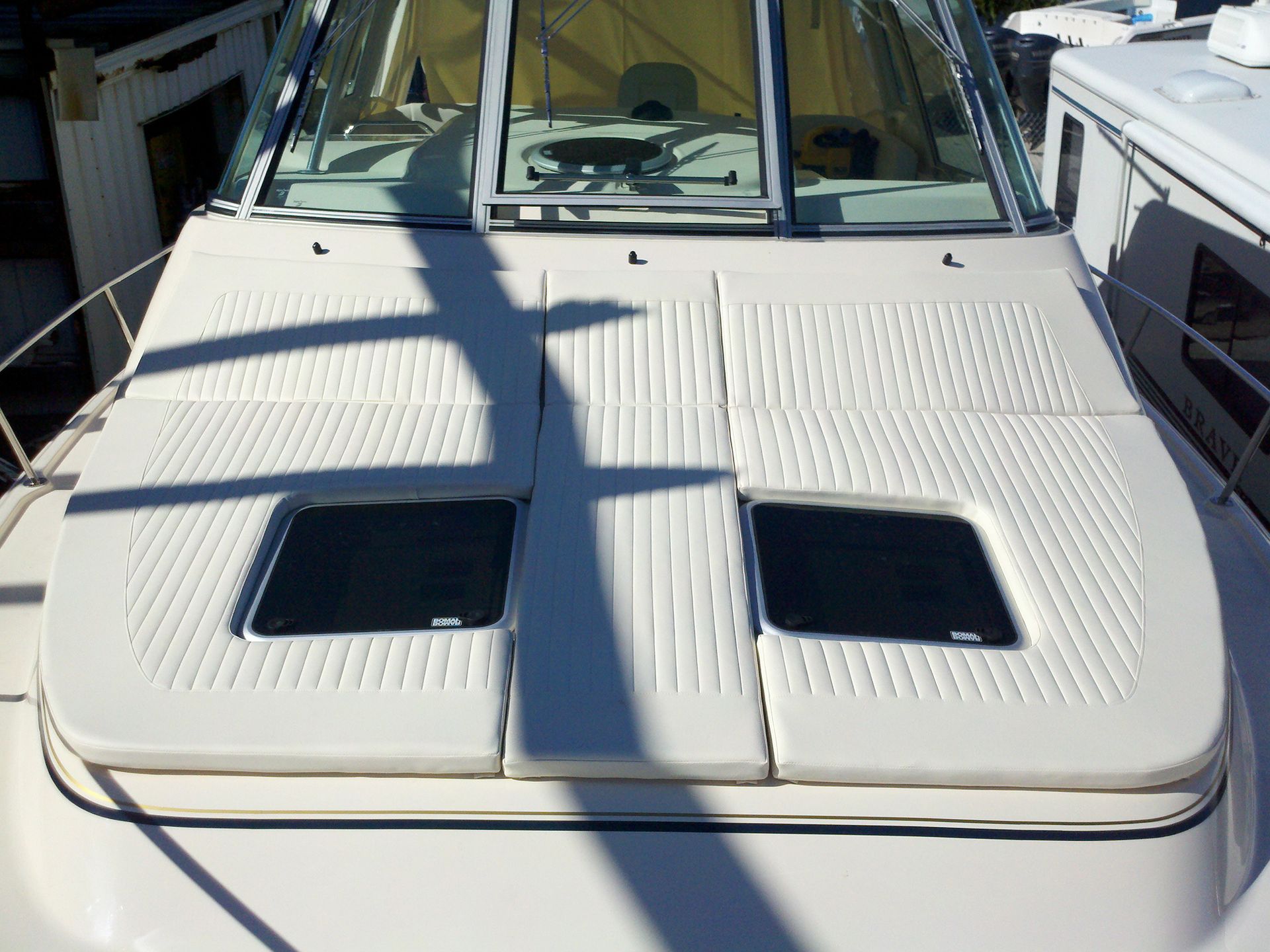 The front of a white boat with two windows