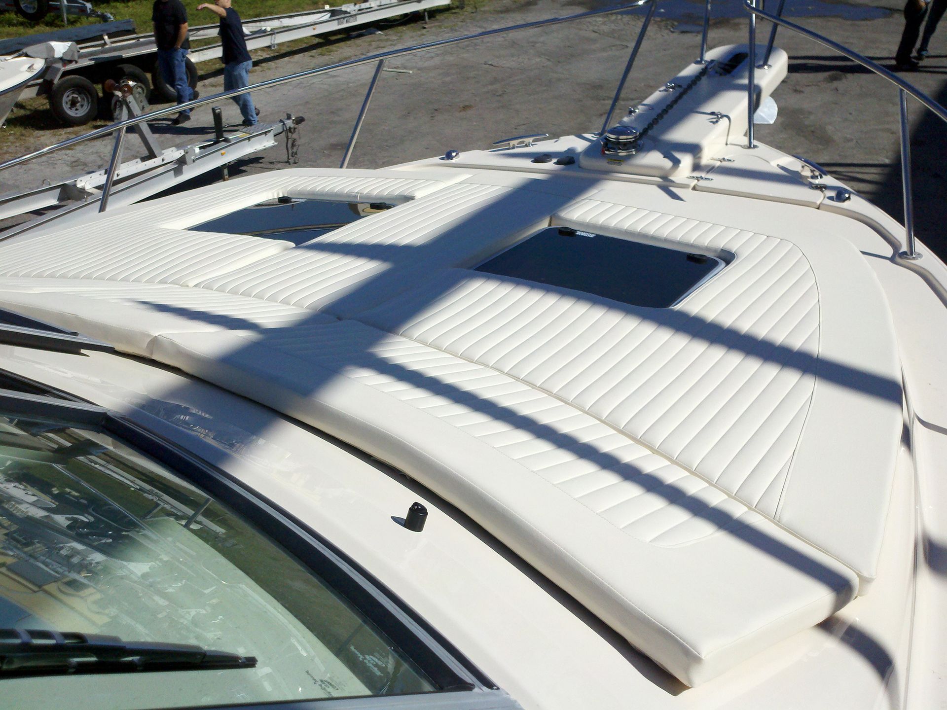 The roof of a white boat has a sunroof