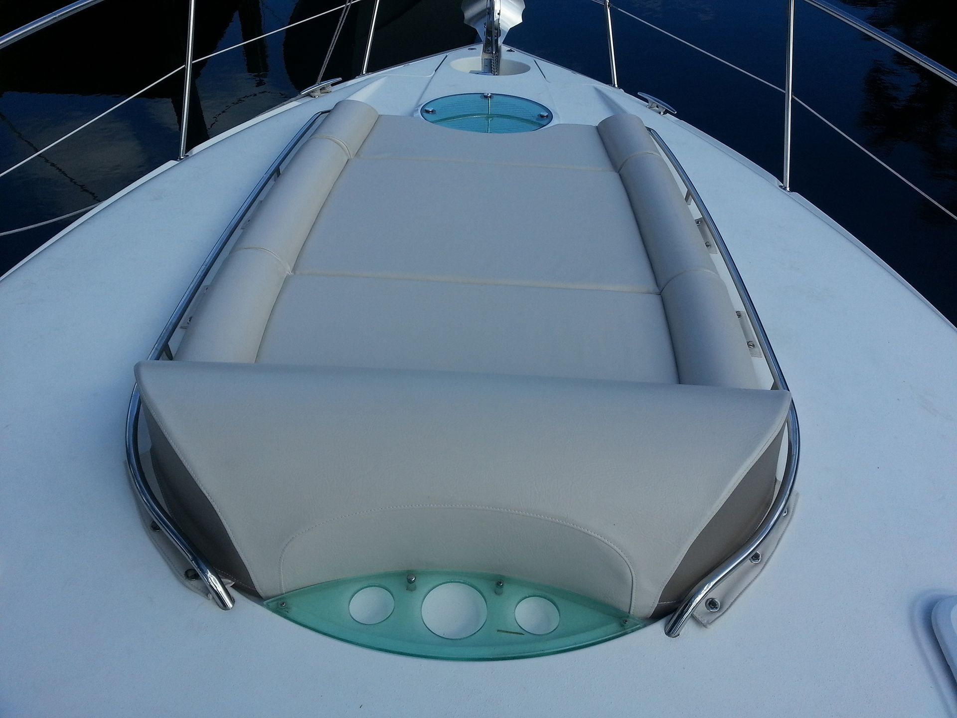 The front of a boat with a cushion on it