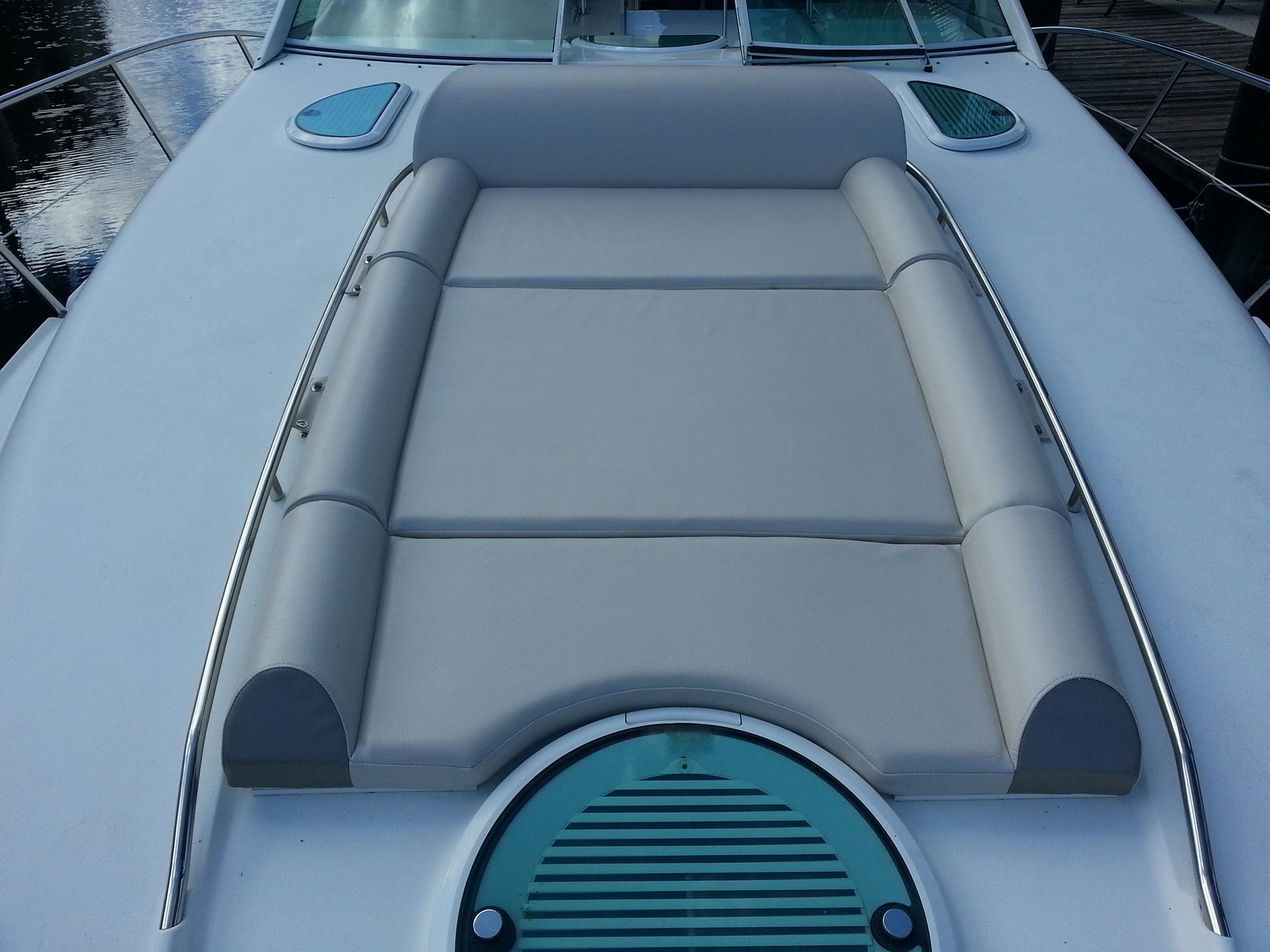 The front of a boat with a cushion on it