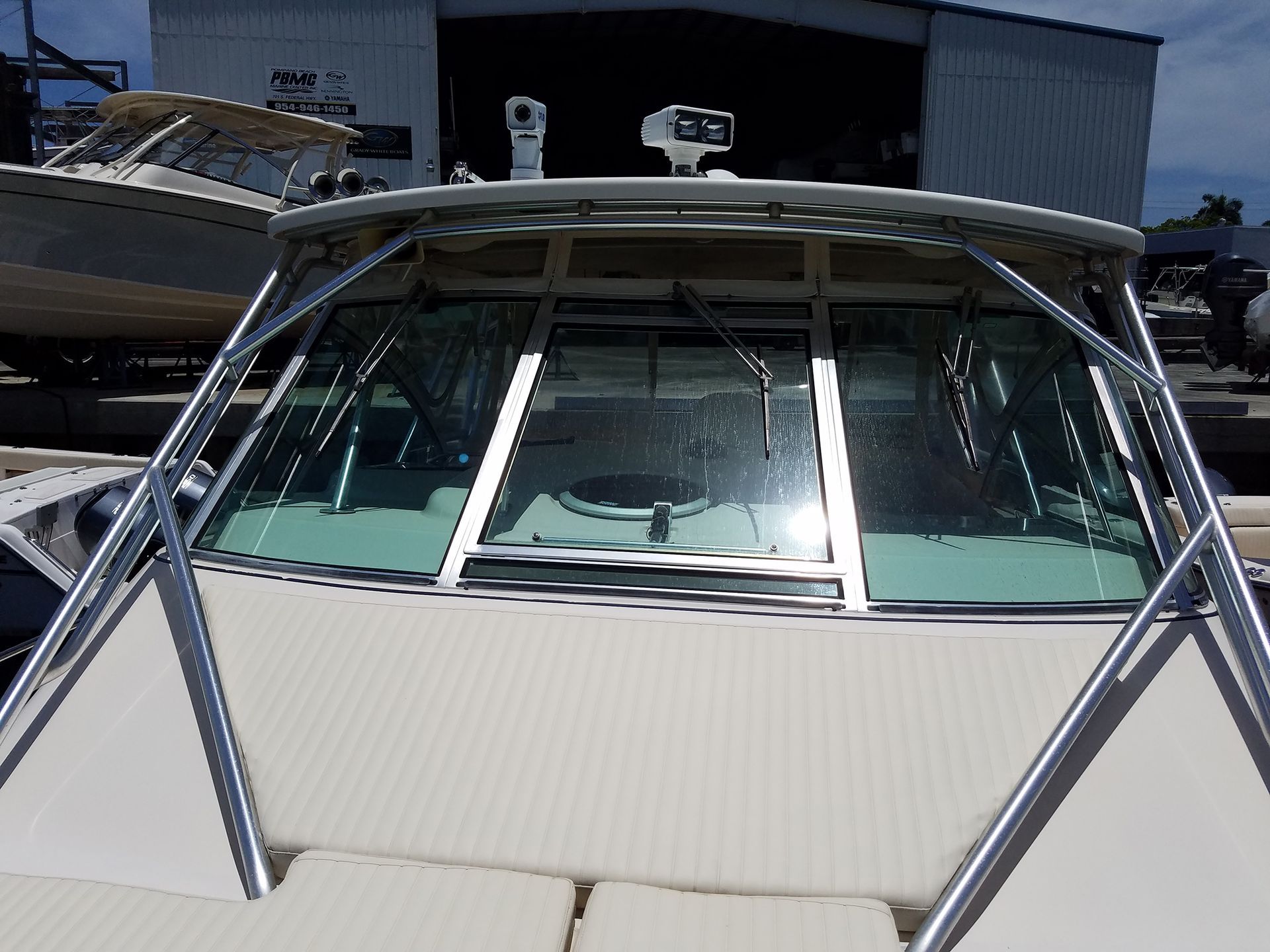 The front of a boat with a large windshield