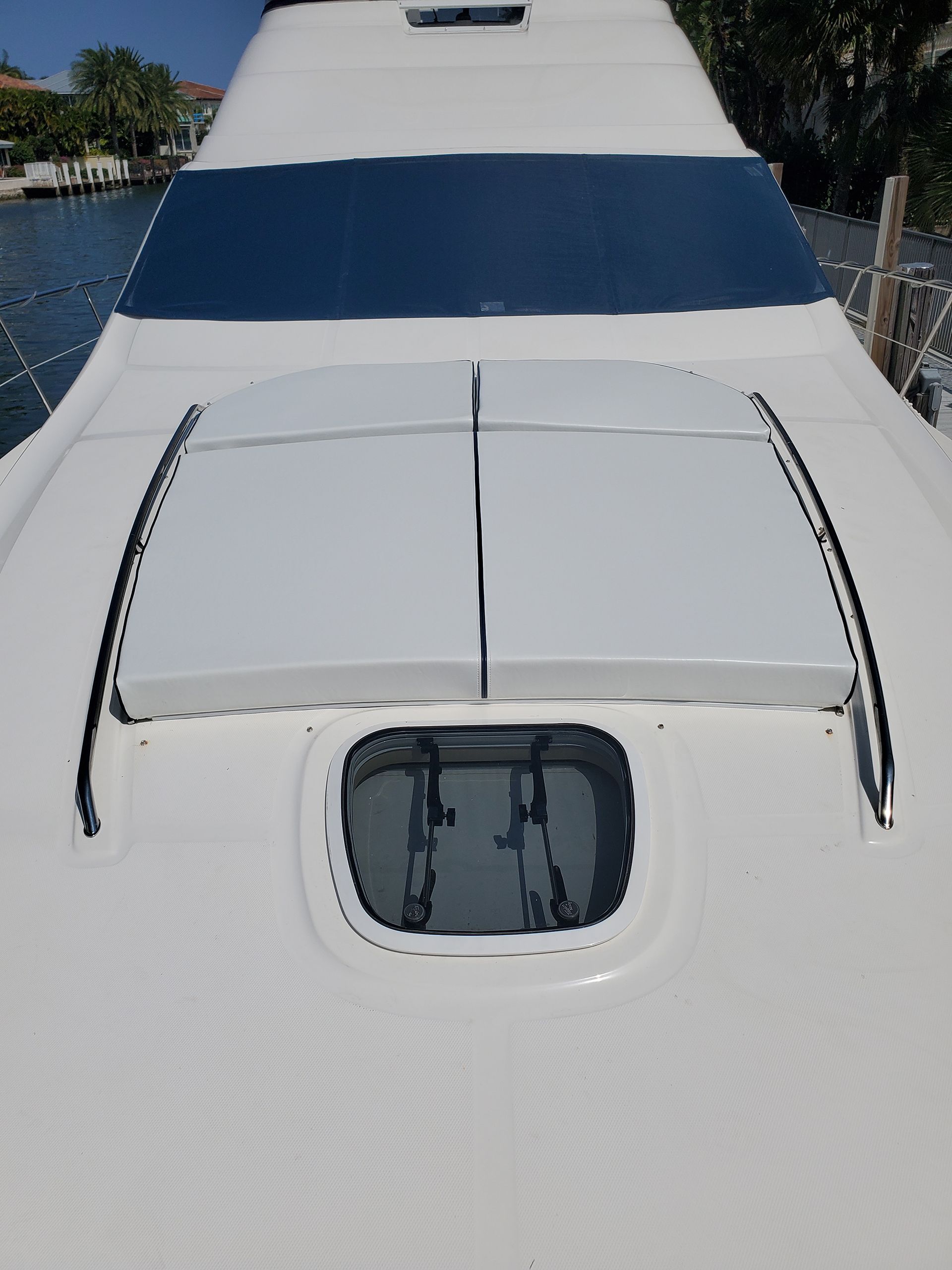 The front of a white boat with a large window