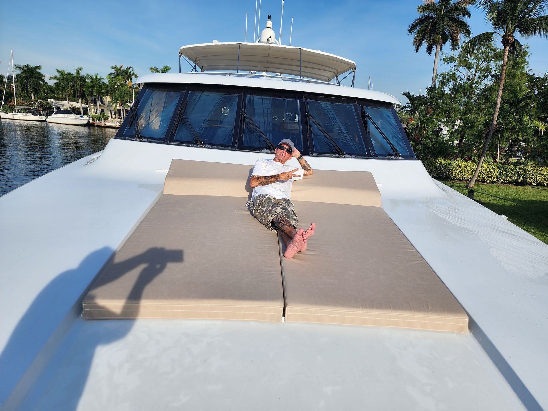A man is laying on the front of a boat