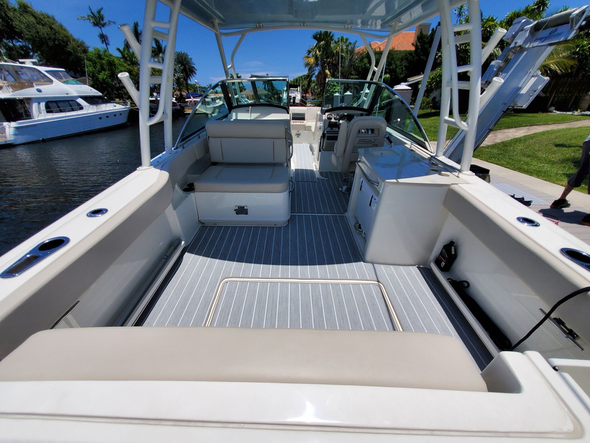 The inside of a white boat with a gray deck