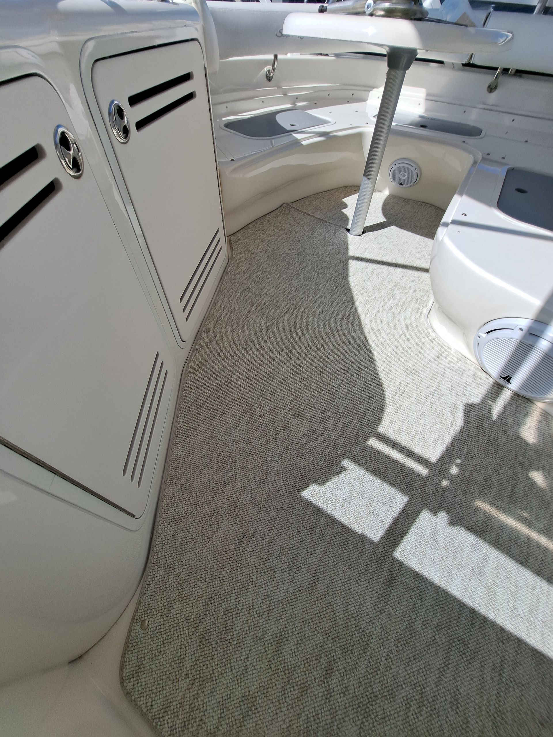 A boat with a carpeted floor and white cabinets