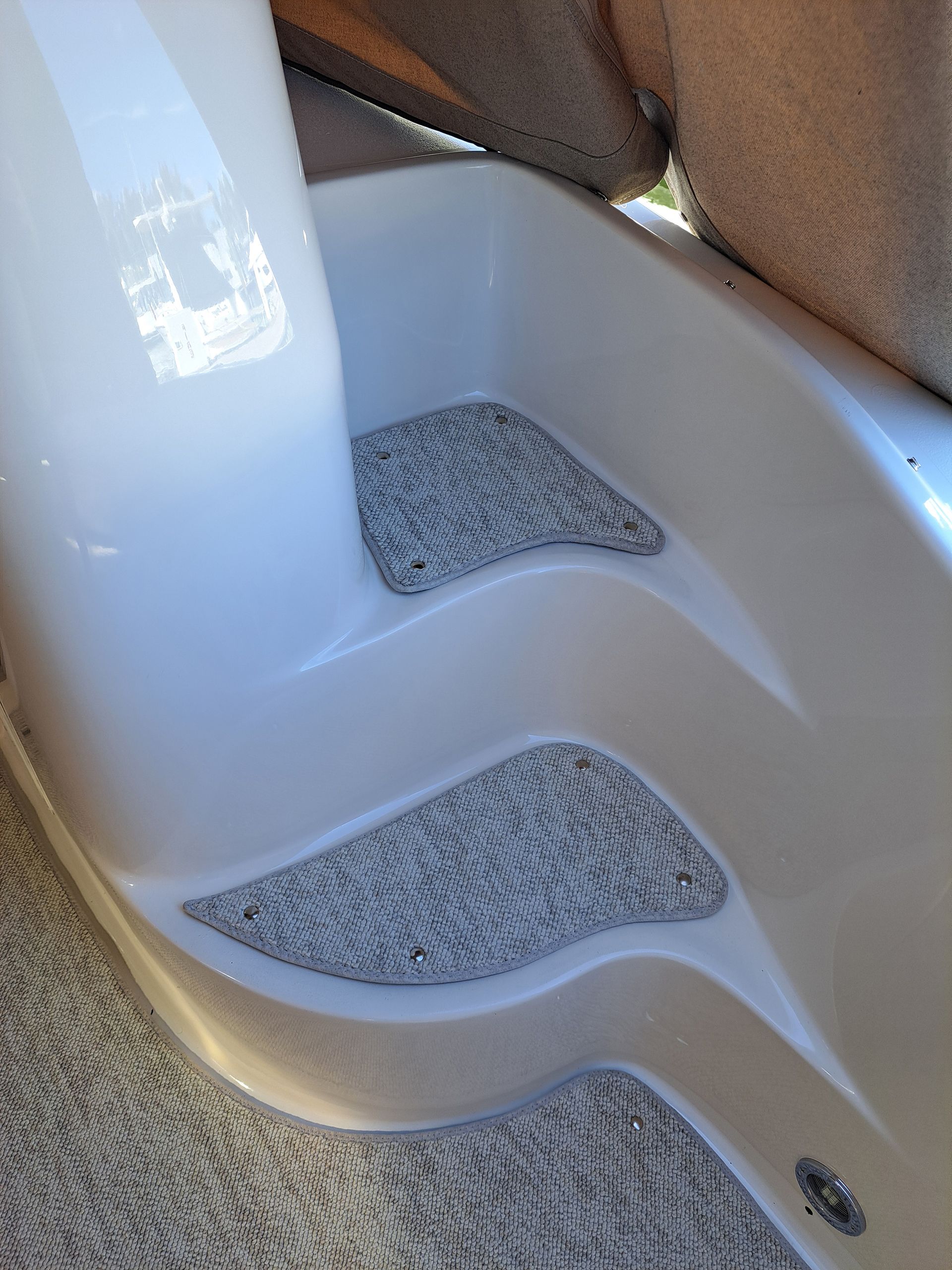 A close up of a white staircase with a carpeted floor