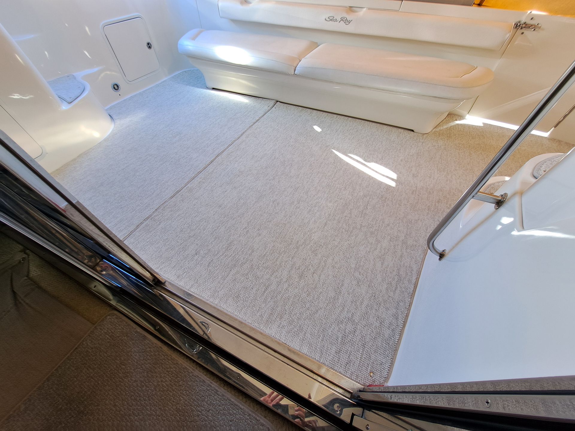 The inside of a boat with a carpeted floor