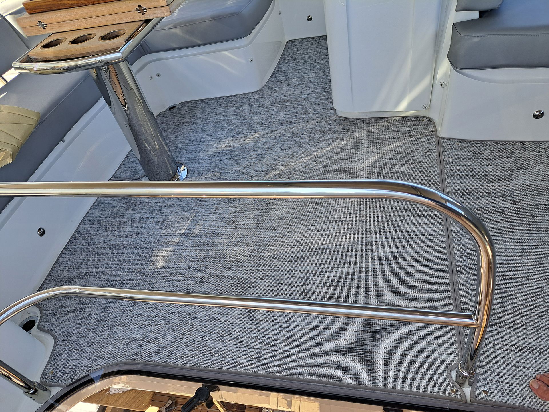 A boat with a stainless steel railing and a table