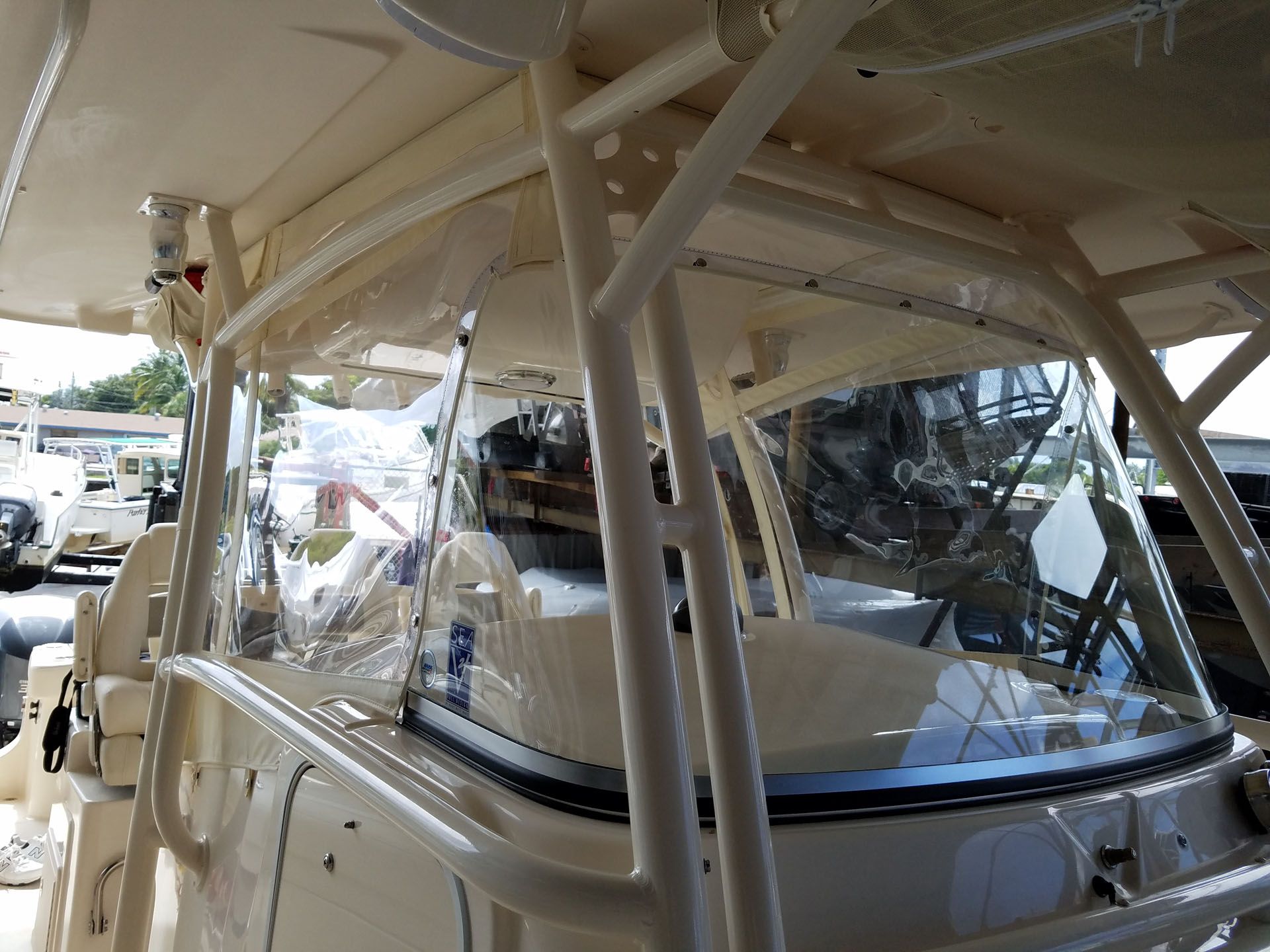 Clear boat enclosure with white supports and a boat interior visible.