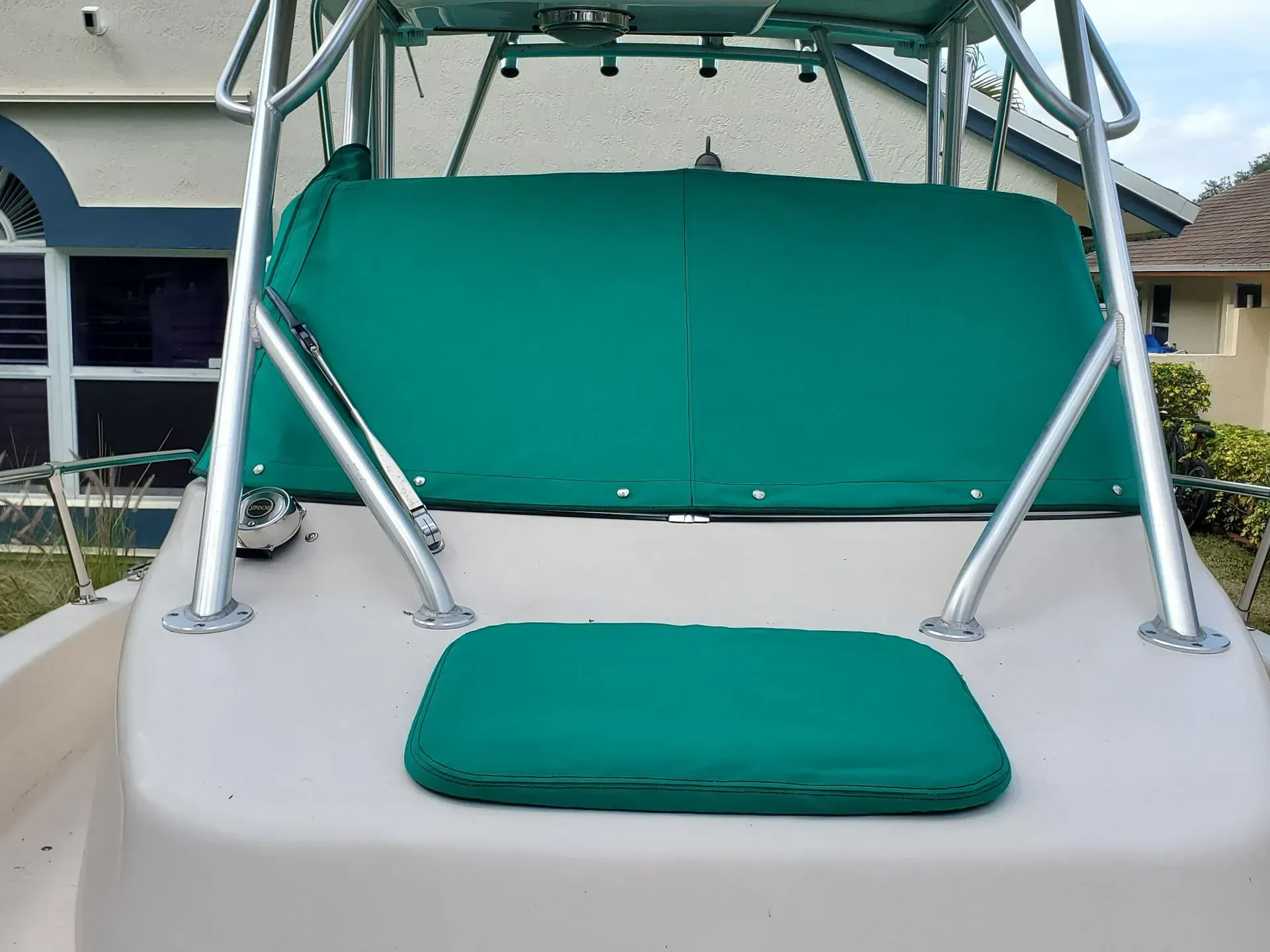 Green cushioned boat seating and canvas top.
